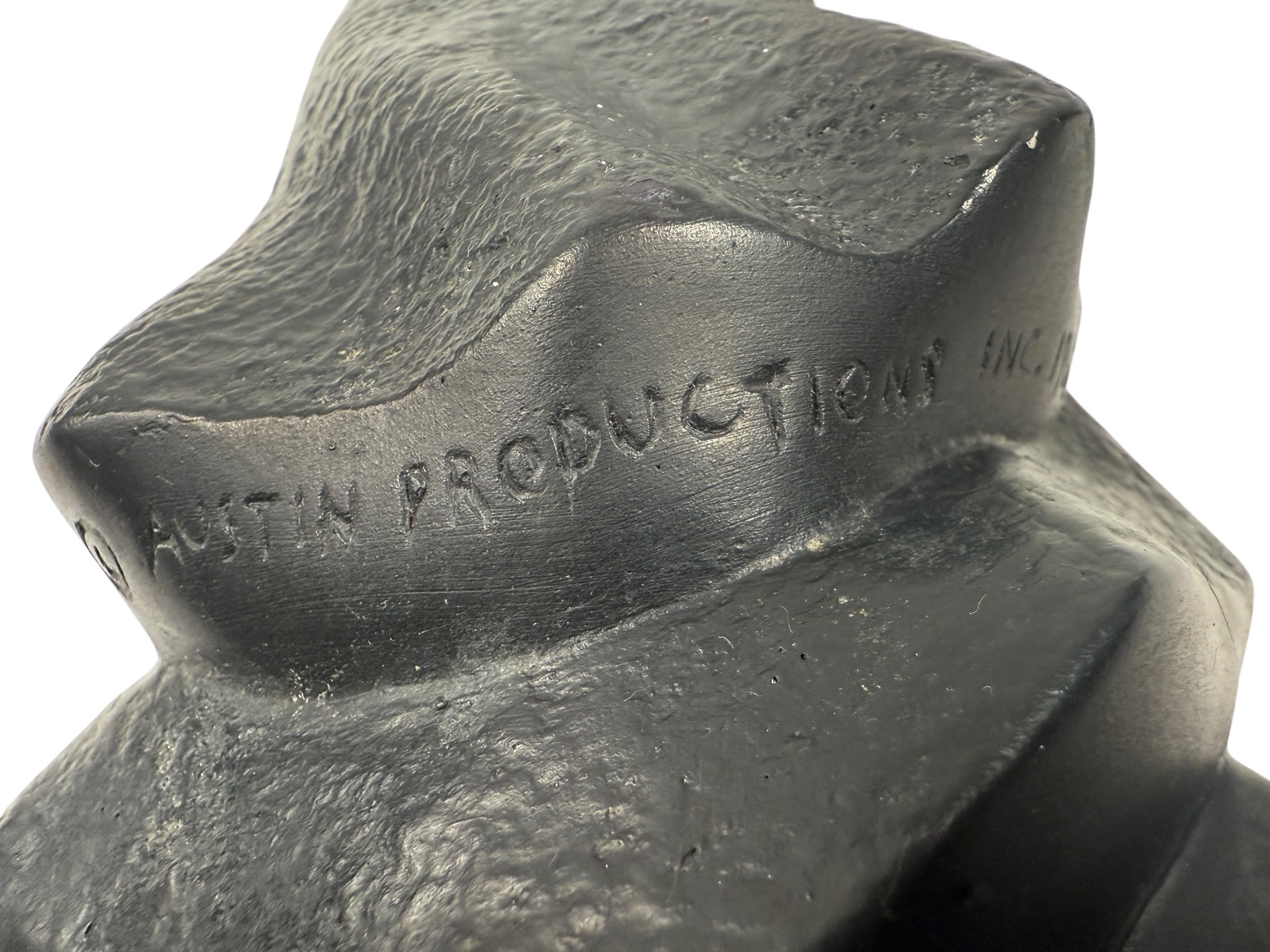 Resin sculpture with 'Crescent Austin Productions Inc.' engraving on a white background