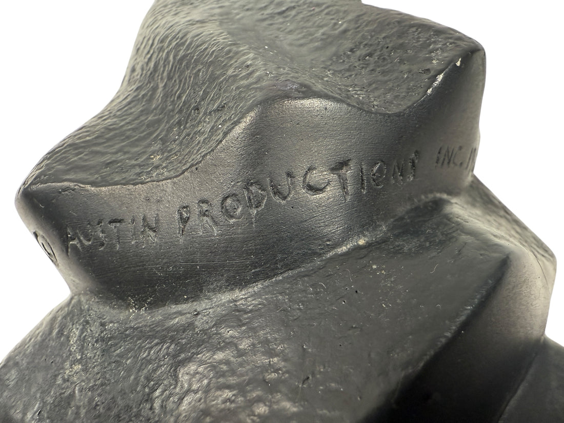 Resin sculpture with 'Crescent Austin Productions Inc.' engraving on a white background