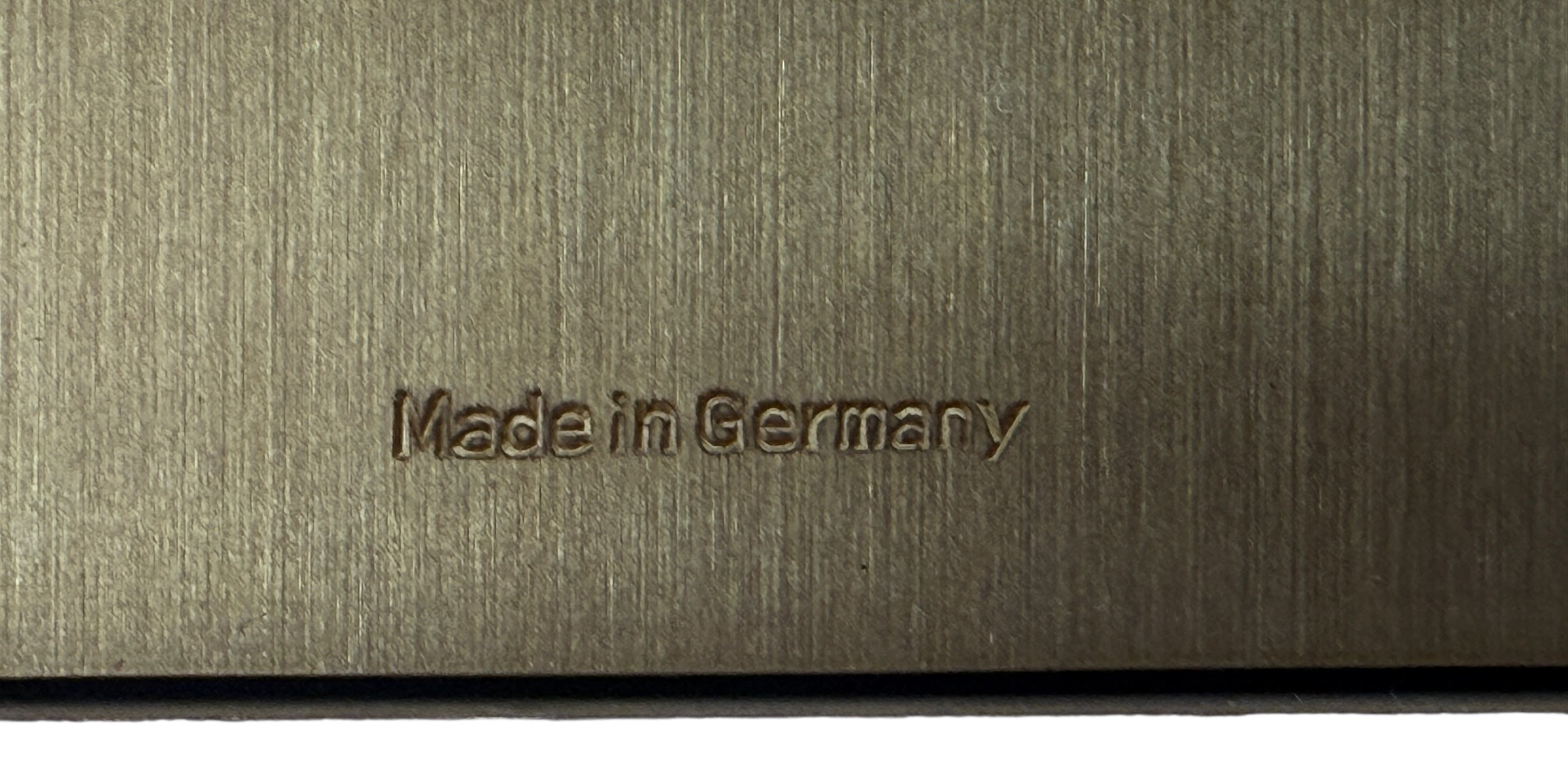 Text 'Made in Germany' embossed on a metallic surface