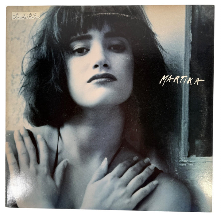 Album cover with a stylized portrait of a woman and the name 'Martika' on a textured background.