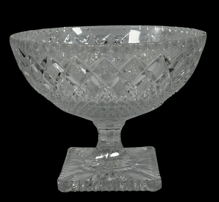 Clear glass bowl with diamond cut pattern on a black background