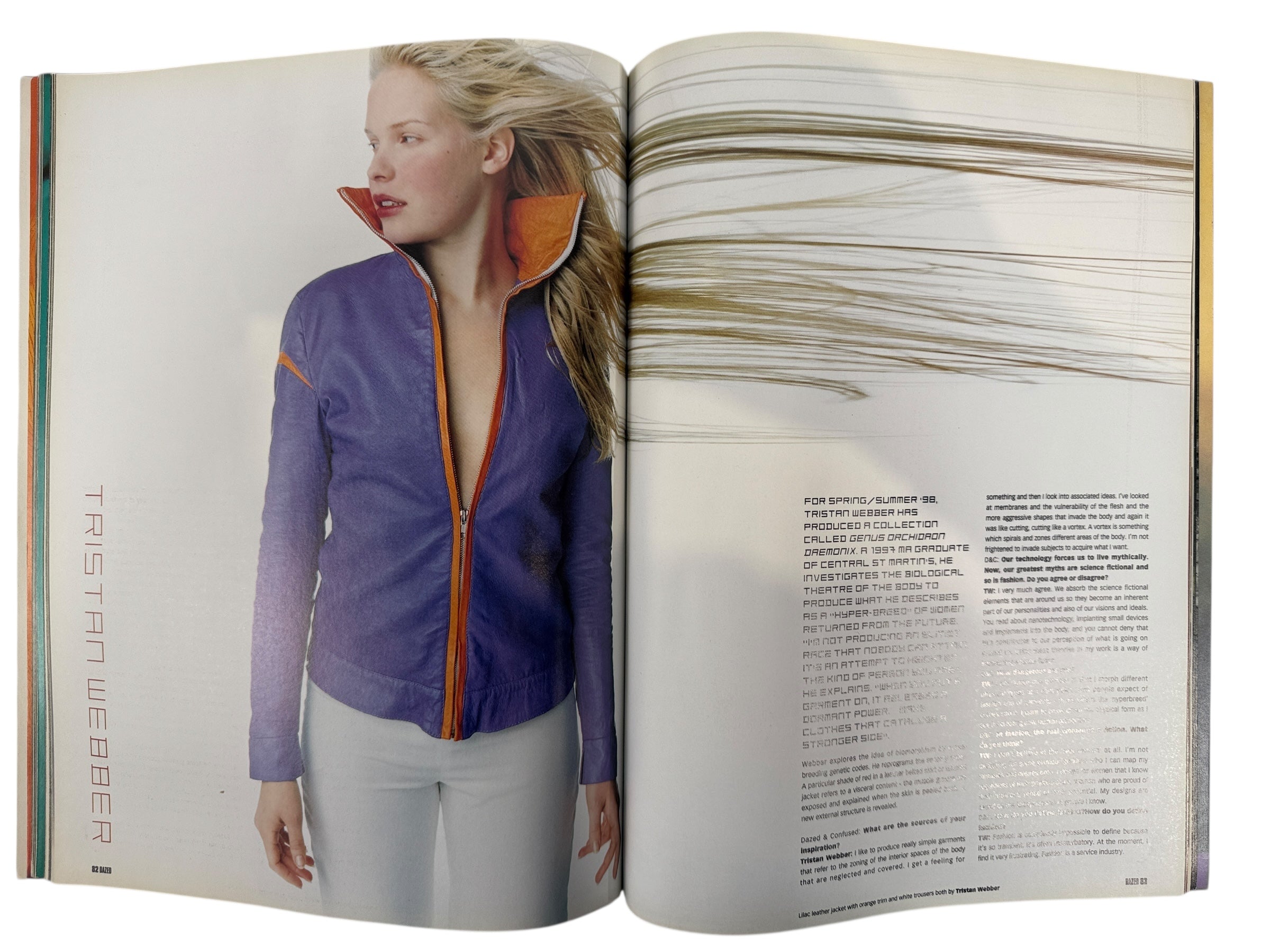 Open magazine showing a person wearing a purple jacket with orange accents