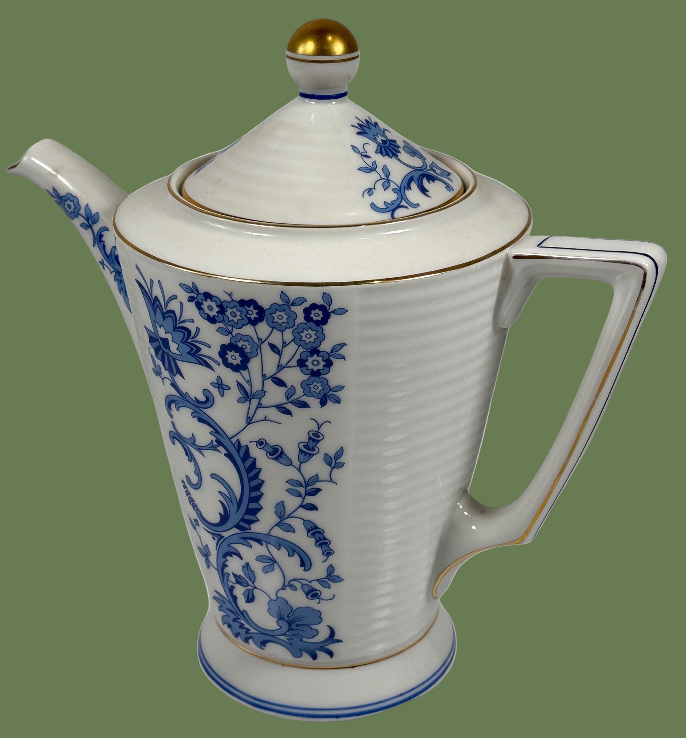 White teapot with blue floral patterns on a white background