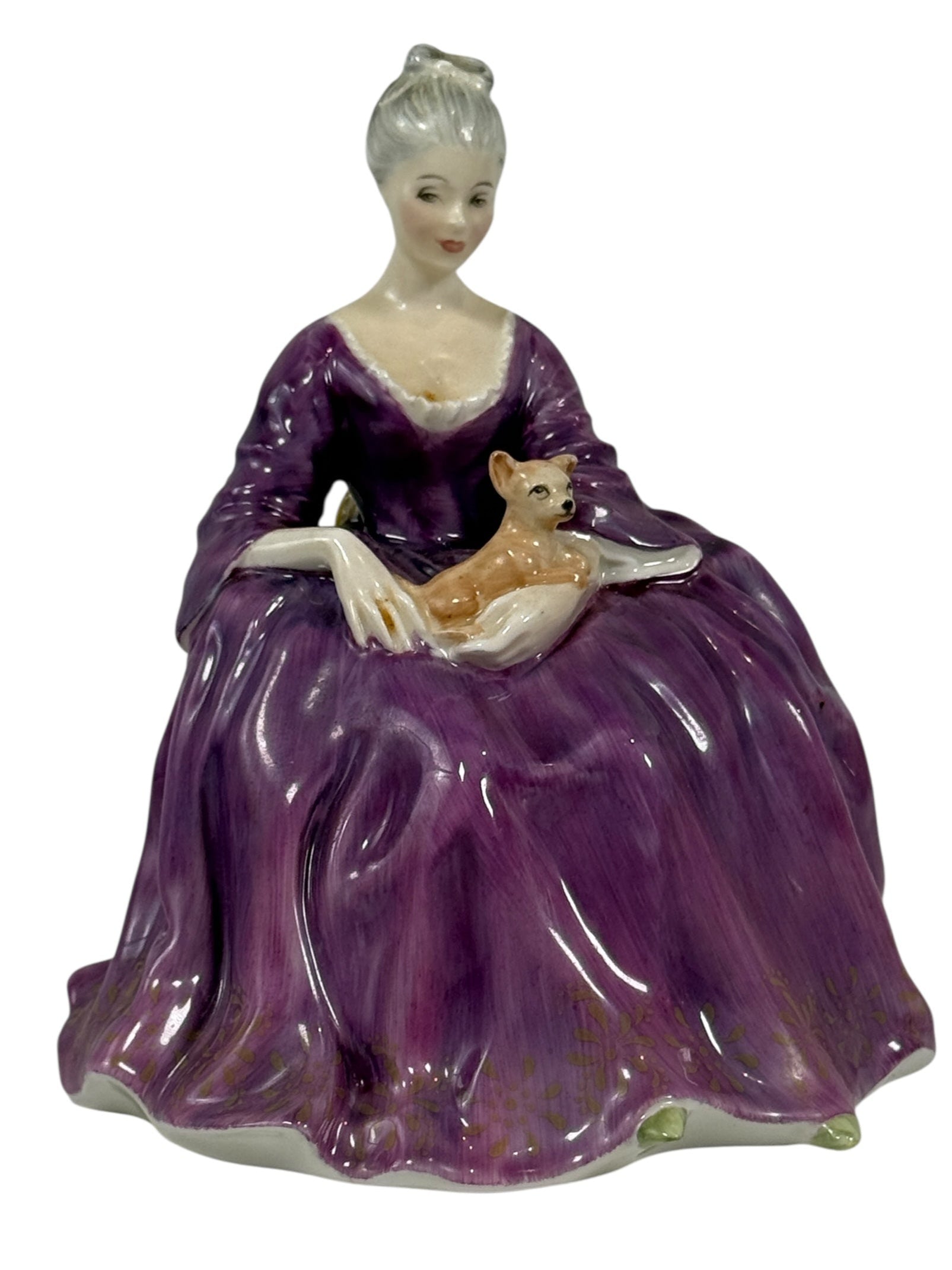 Porcelain figurine of a woman in a purple gown holding a fox on a white background