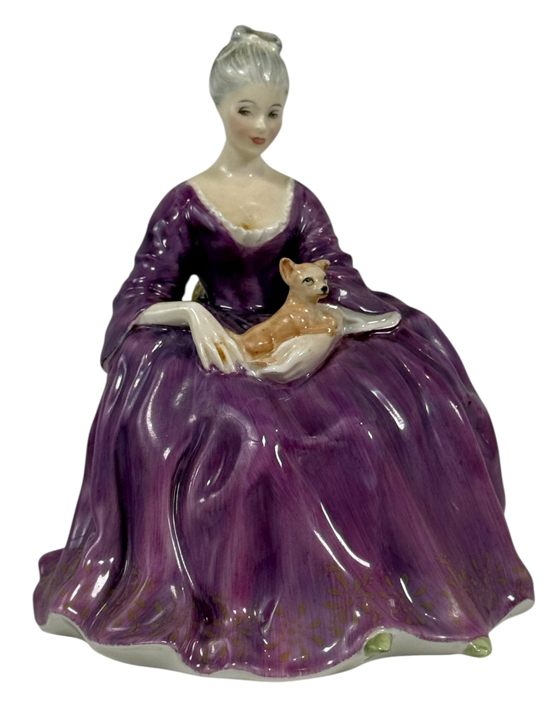 Porcelain figurine of a woman in a purple gown holding a fox on a white background