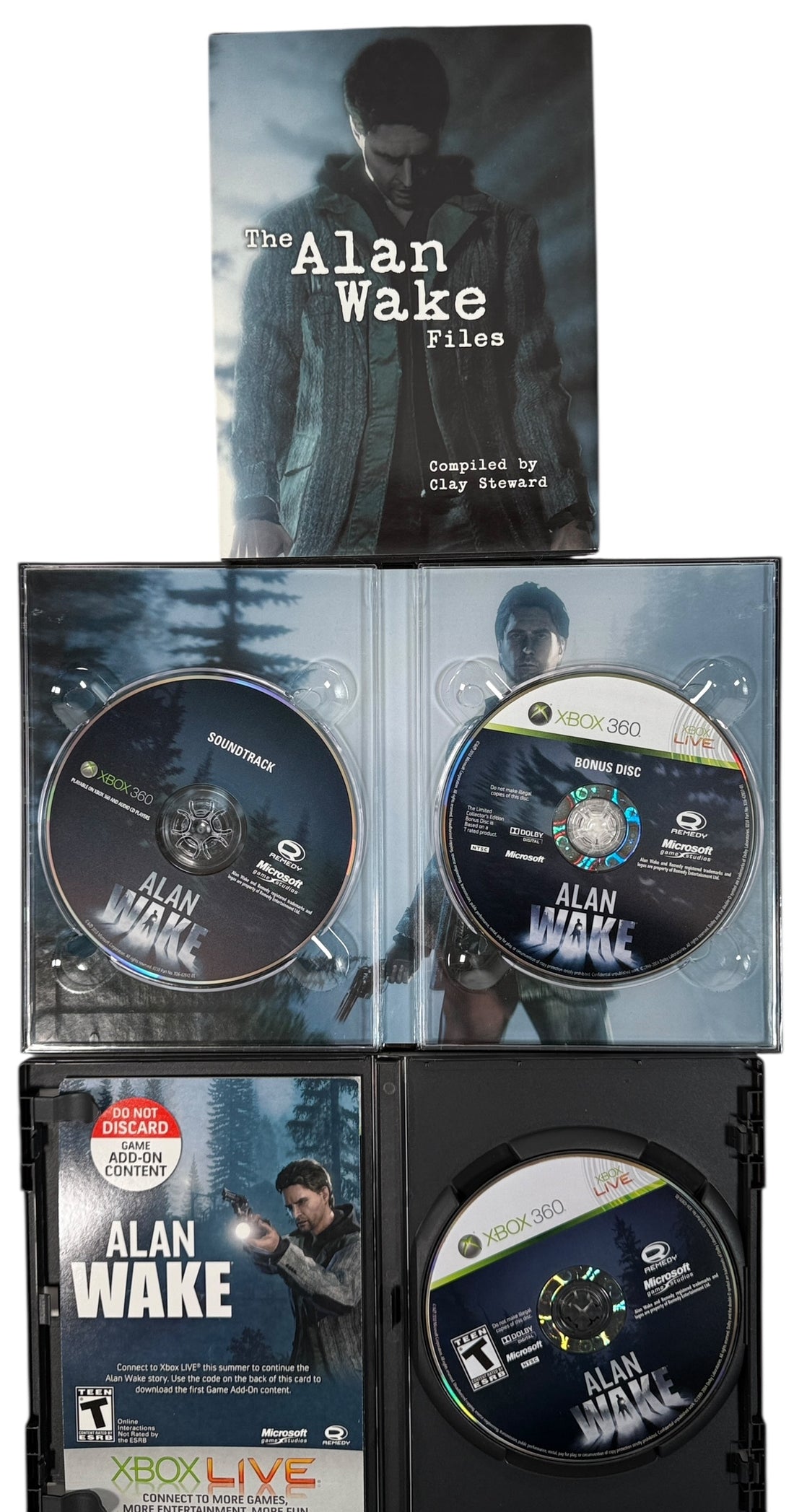 Collection of 'Alan Wake' game components including case, discs, and manual on a white background