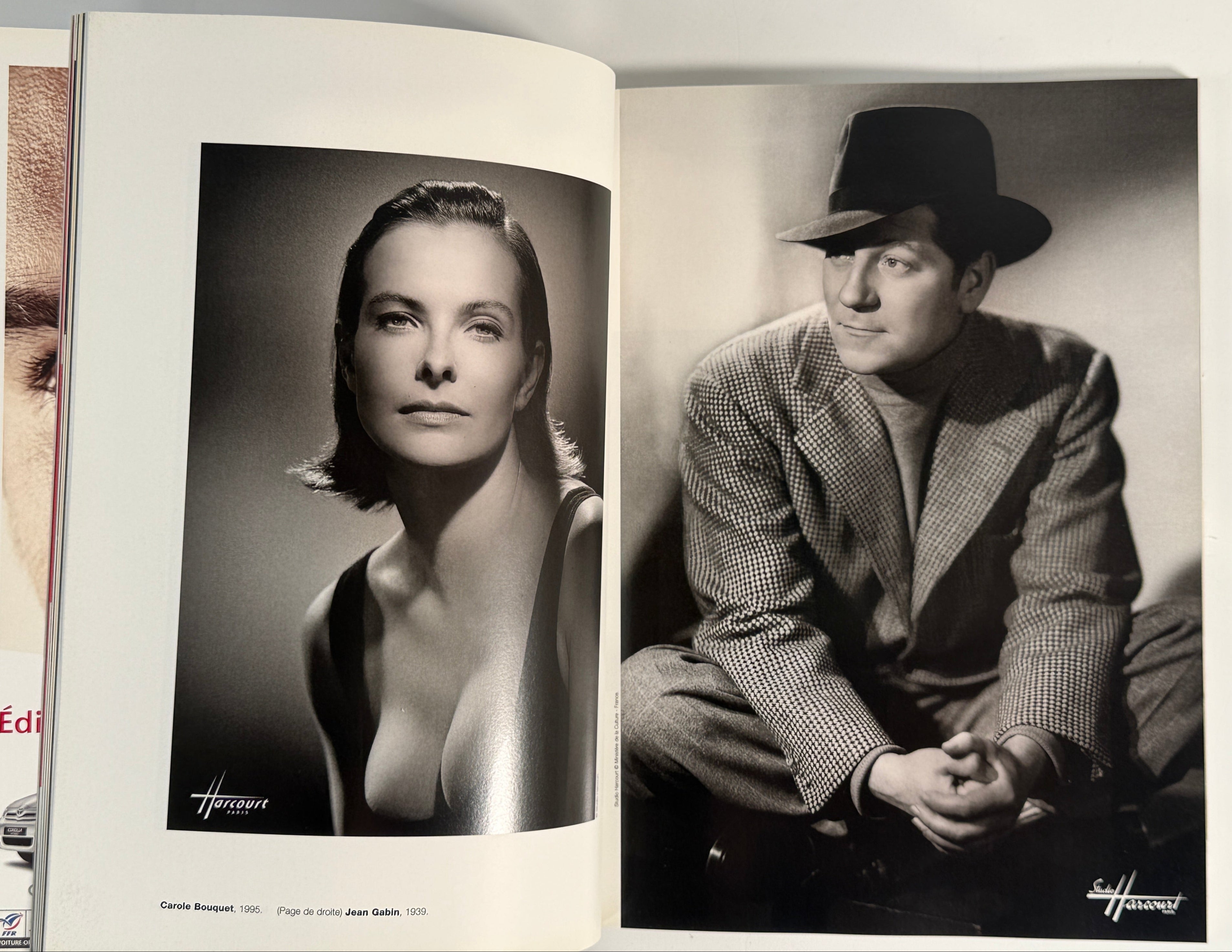 Open book with black and white photographs of a woman and a man on the pages.