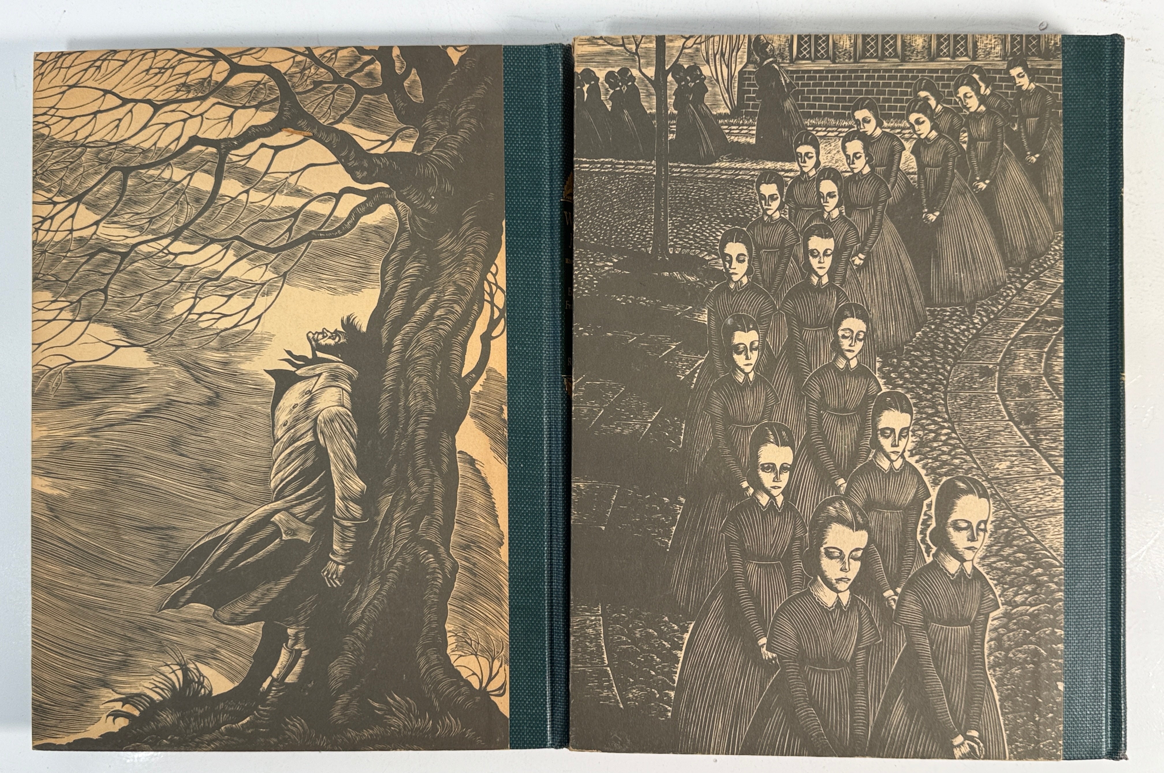 Book with engraved illustrations on the cover, featuring a figure by a tree and a group of people.