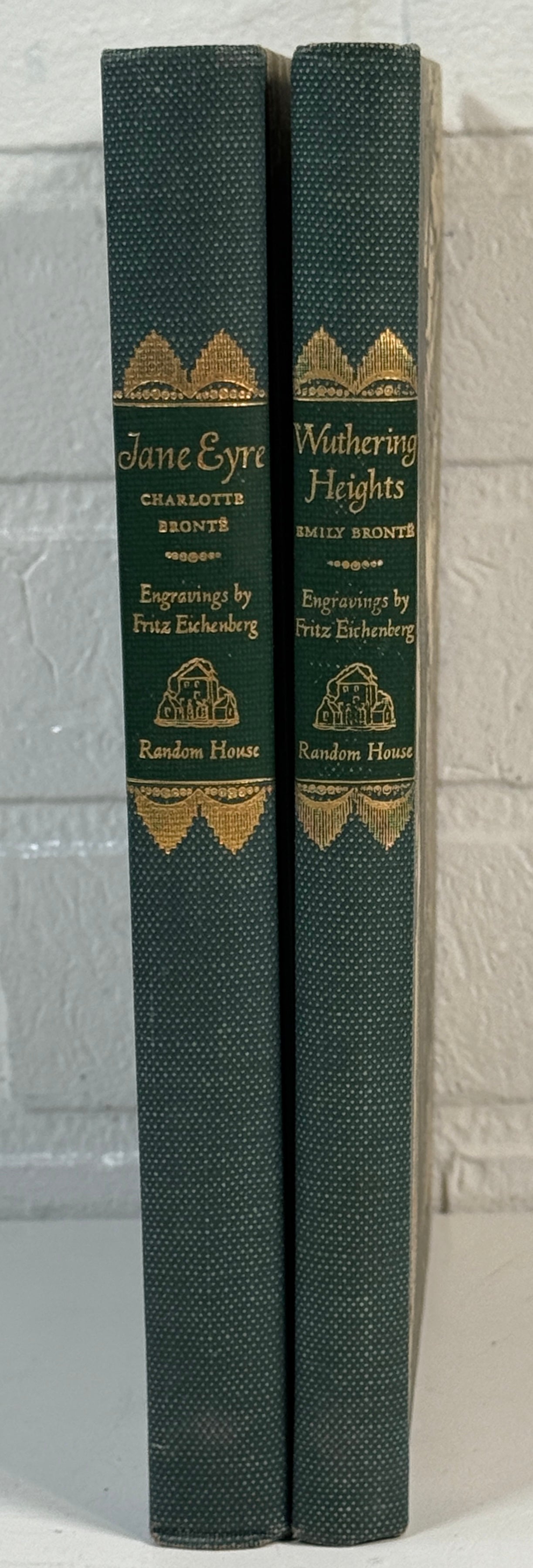 Two books titled 'Jane Eyre' and 'Wuthering Heights' by Charlotte Bronte, bound together with decorative gold embossed text on a gray background.