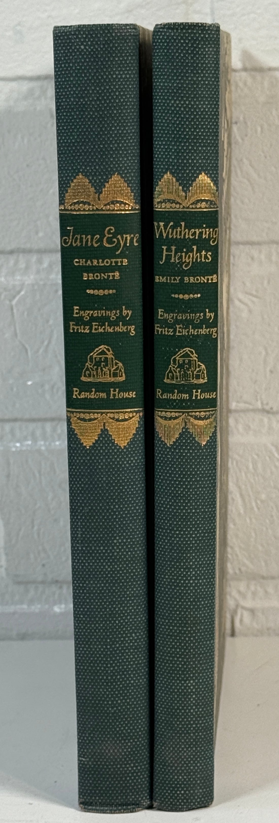 Two books titled 'Jane Eyre' and 'Wuthering Heights' by Charlotte Bronte, bound together with decorative gold embossed text on a gray background.