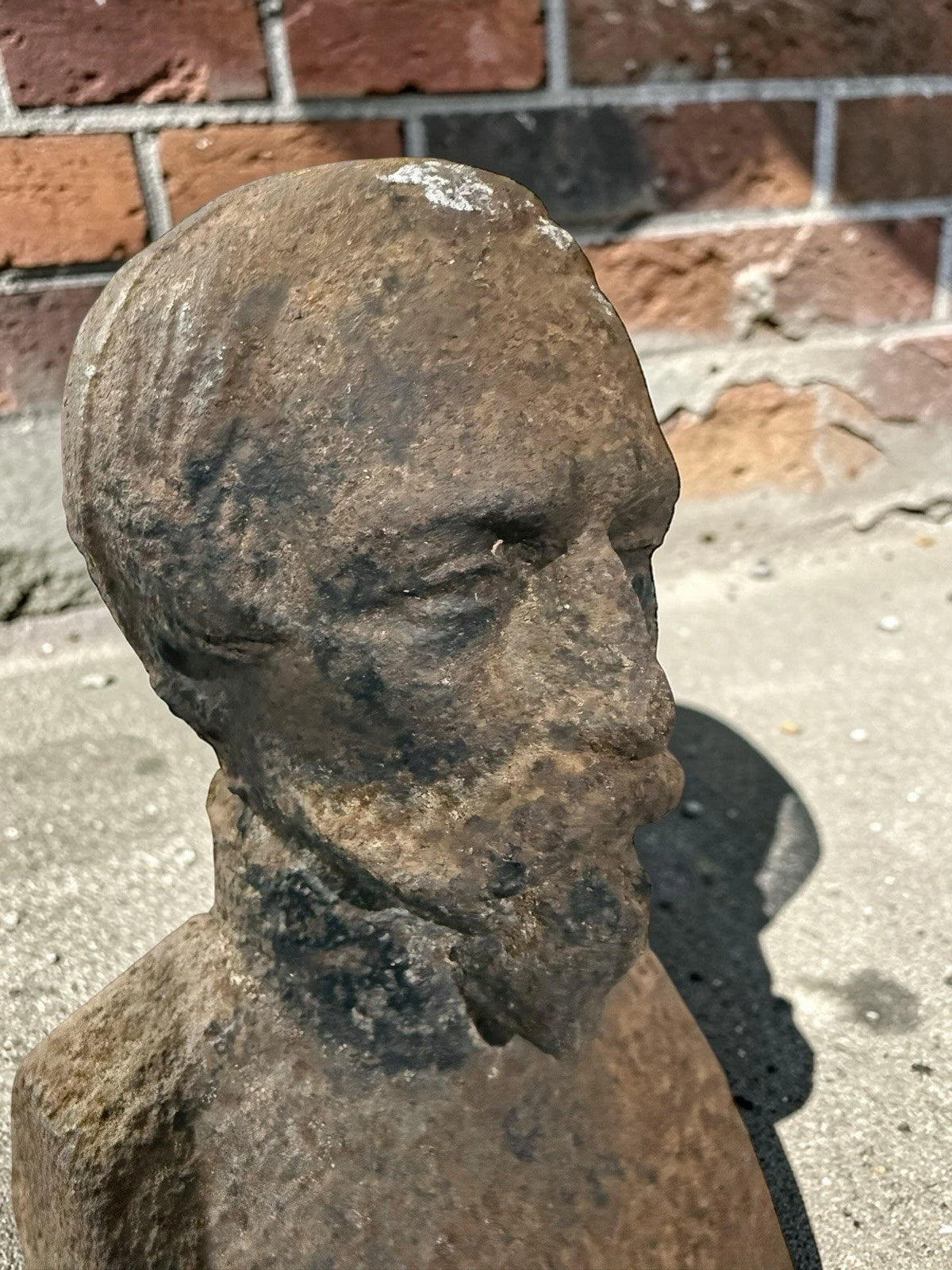 Antique French cast iron chenets with male bust fronts. Decorative fireplace firedogs / andirons with aged black patina and historic hearth appeal.
