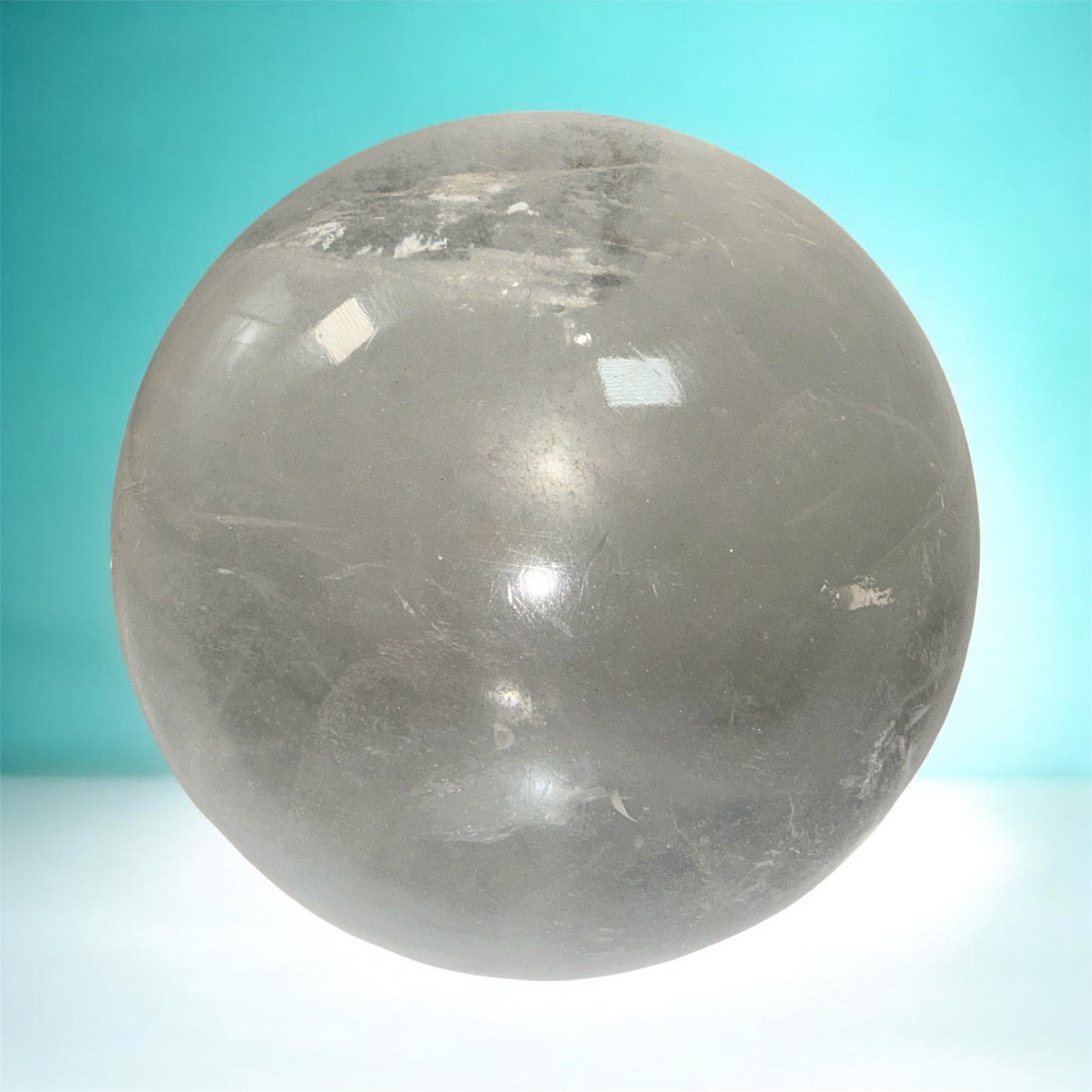 Natural clear quartz crystal sphere 70mm polished orb with beautiful internal veils and inclusions. Decorative display piece for collectors or décor.