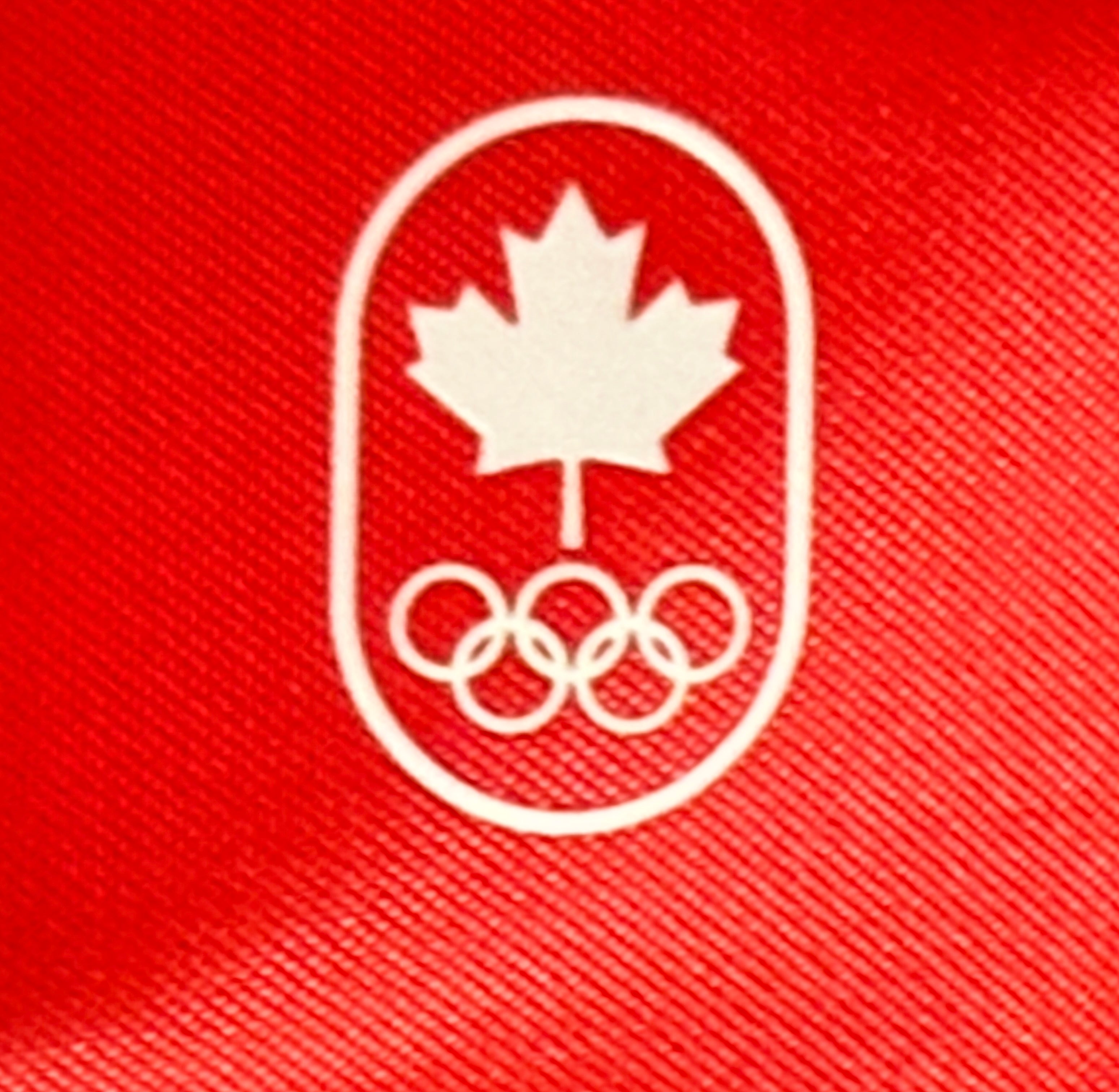 Official Lululemon Team Canada rolling suitcase in vibrant Olympic red. Large wheeled travel luggage with spacious interior, compression straps, and rare Canadian Olympic branding