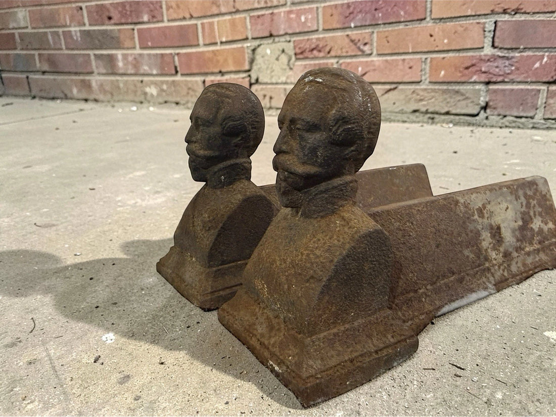 Antique French cast iron chenets with male bust fronts. Decorative fireplace firedogs / andirons with aged black patina and historic hearth appeal.