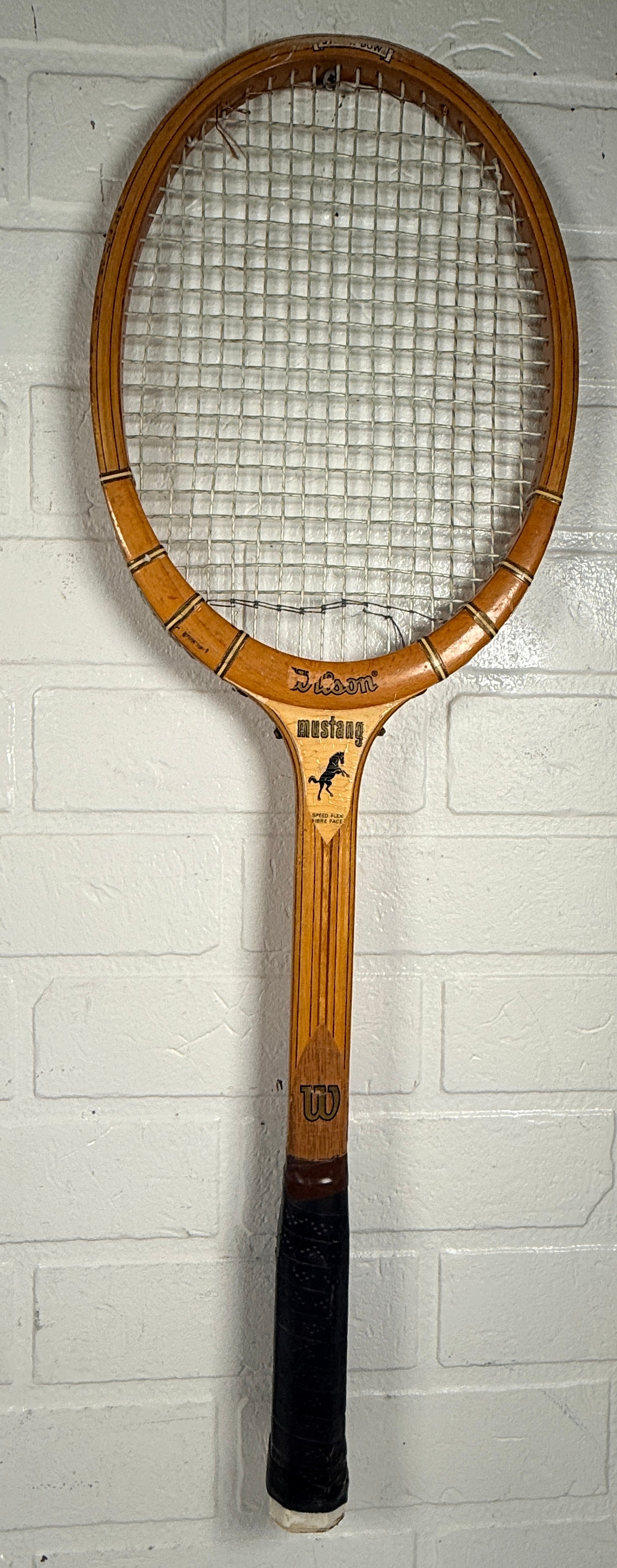 Vintage Wilson Mustang wooden tennis racket with Speed Flex Fibre Face construction. Classic mid-century tennis memorabilia and decorative sports display piece.
