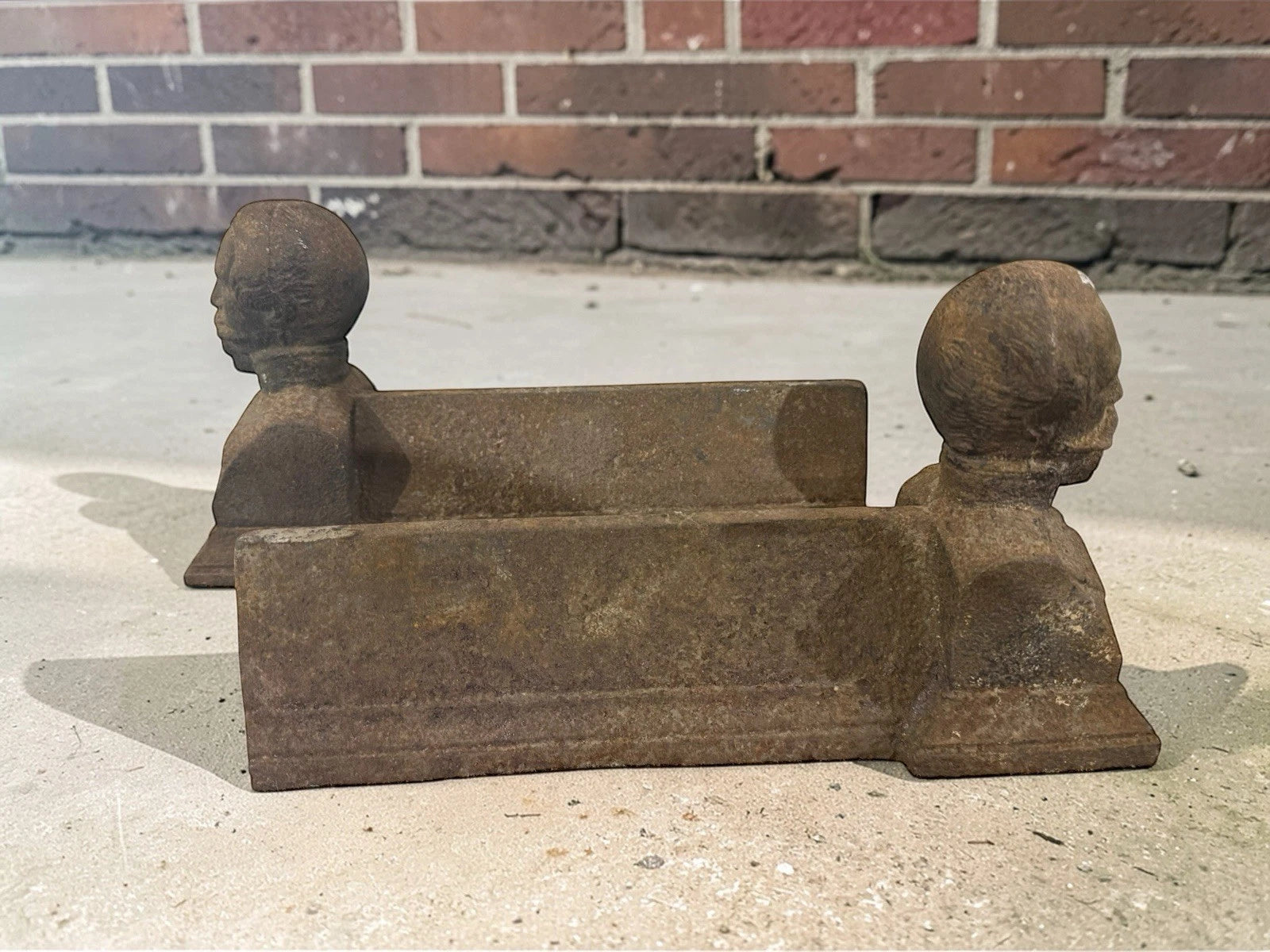 Antique French cast iron chenets with male bust fronts. Decorative fireplace firedogs / andirons with aged black patina and historic hearth appeal.