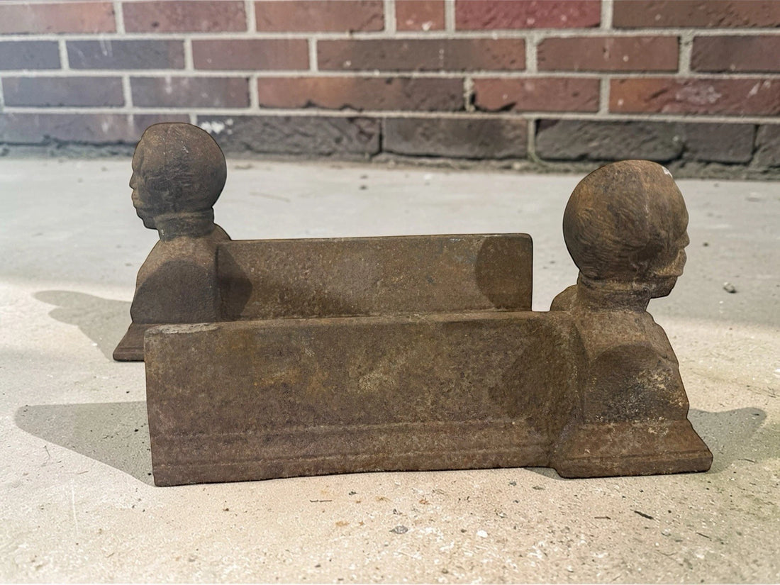 Antique French cast iron chenets with male bust fronts. Decorative fireplace firedogs / andirons with aged black patina and historic hearth appeal.