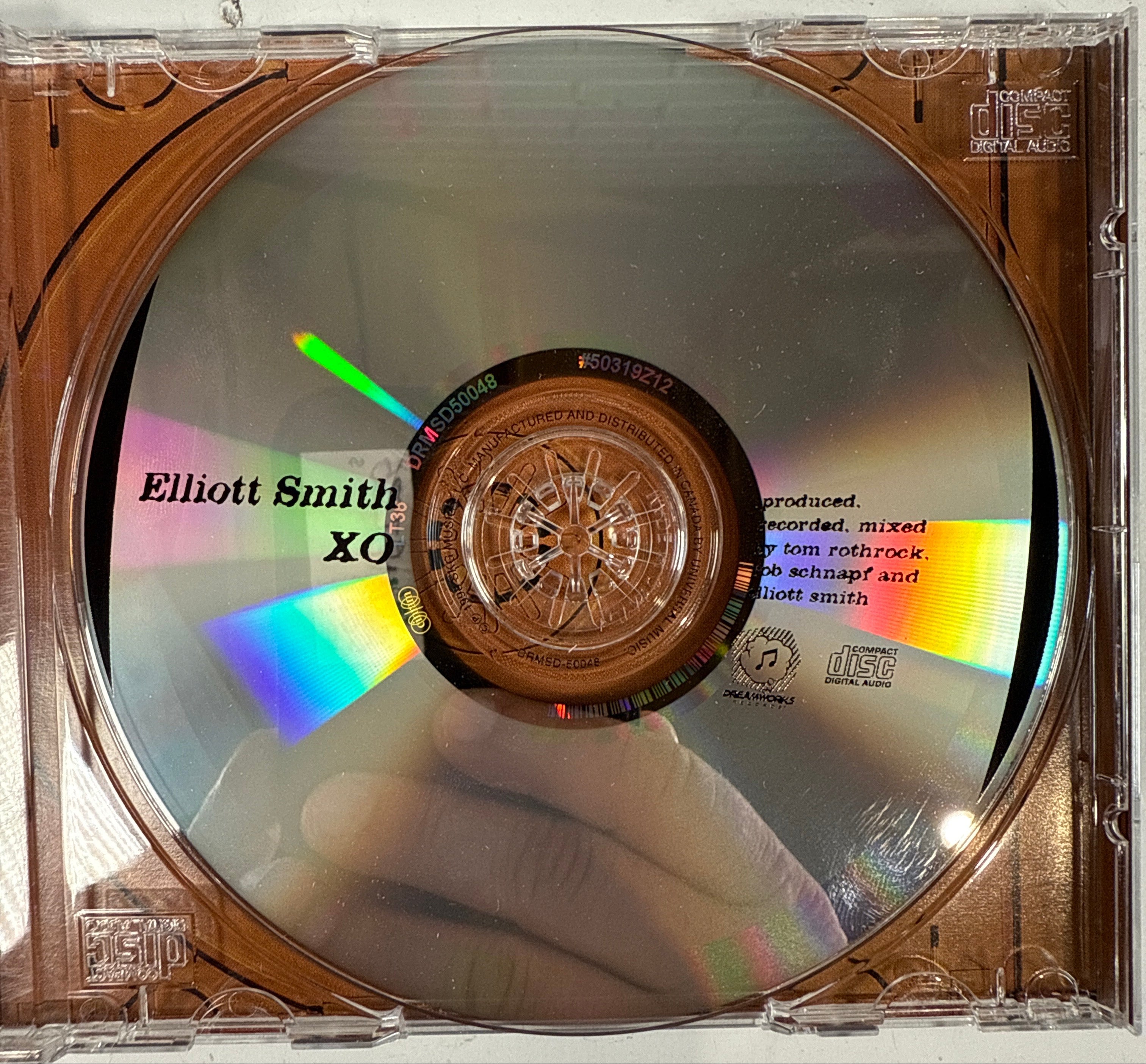 CD in a clear case with a colorful label on a white background