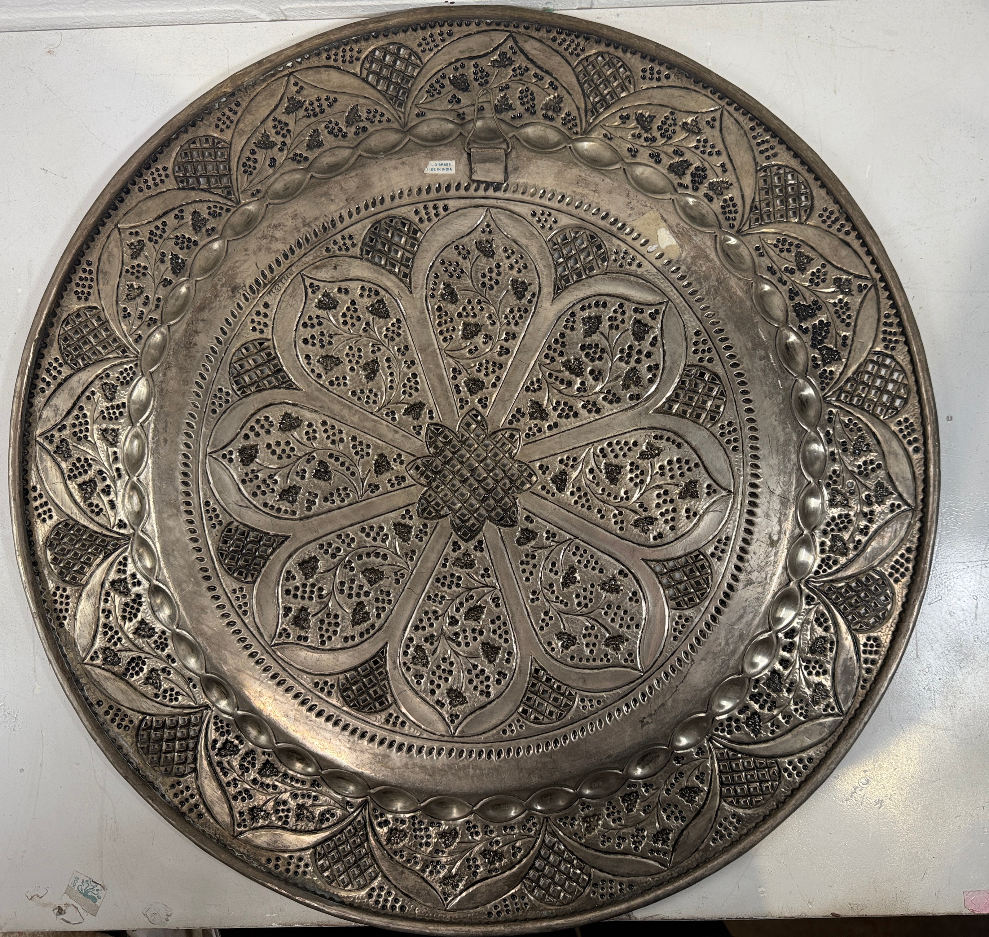 Vintage 24” solid brass tray made in India with hand-chased floral design and pierced edging. Ideal for décor or table use. Classic mid-century export piece.