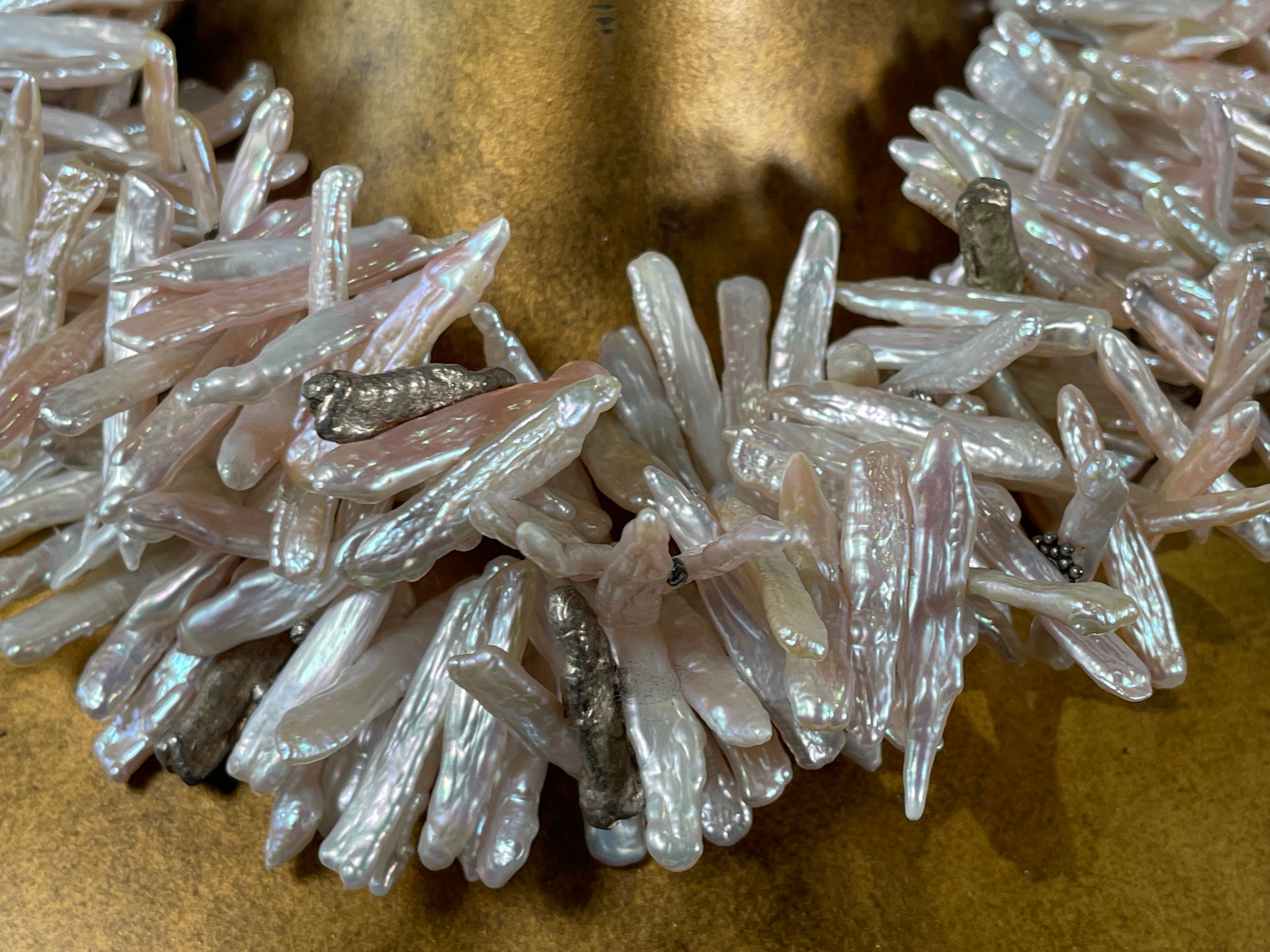 Close-up of a cluster of white crystals on a brown background
Baroque_Pearl_Necklace 