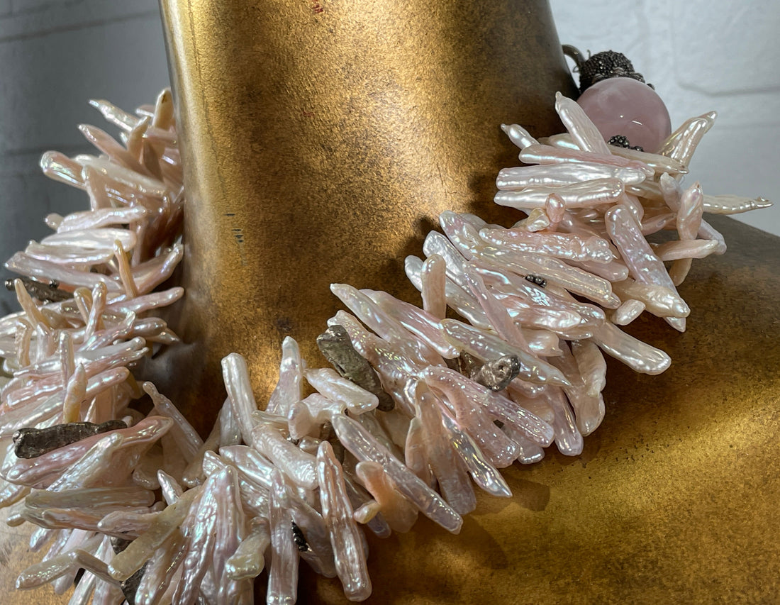 Close-up of a decorative item with crystals on a gold surface
Baroque_Pearl_Necklace 