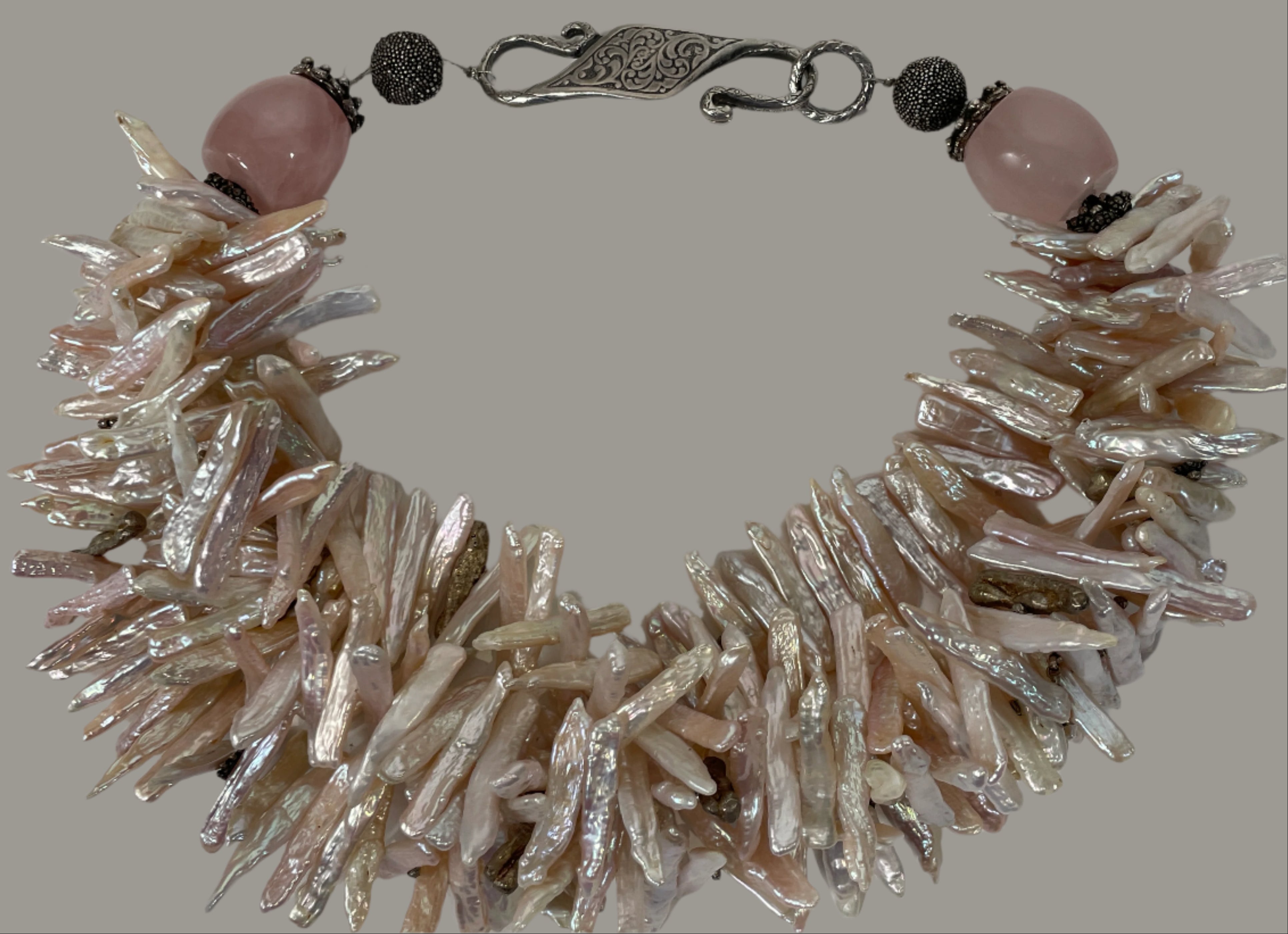 Bracelet with natural pearl-like beads and pink stones on a white background
Baroque_Pearl_Necklace 