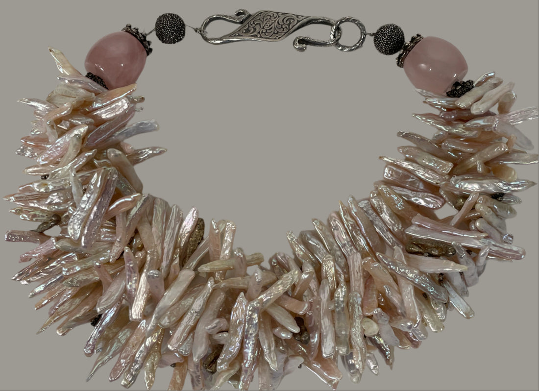 Bracelet with natural pearl-like beads and pink stones on a white background
Baroque_Pearl_Necklace 