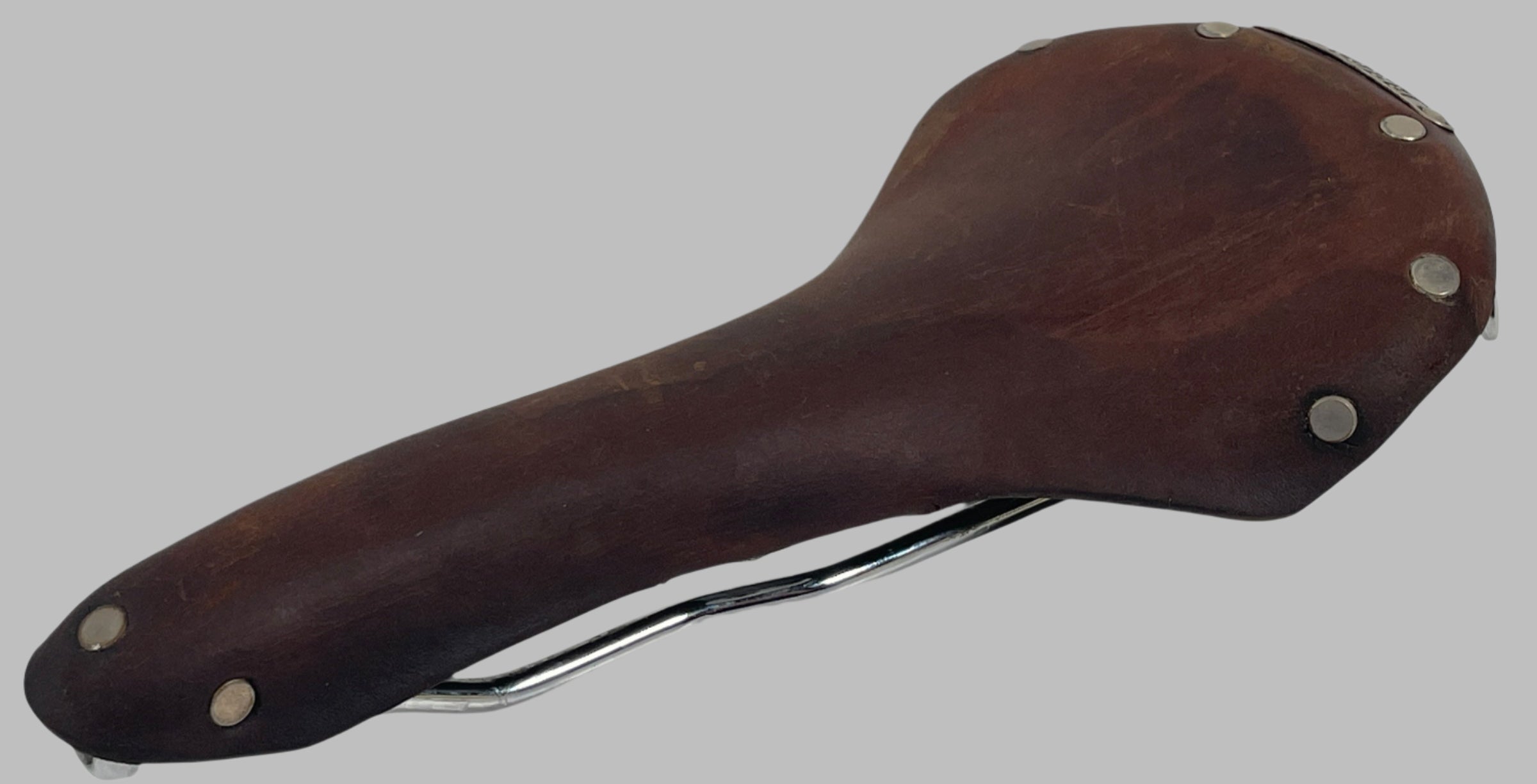 Brooks, England, Wooden bicycle saddle with metal hardware on a white background