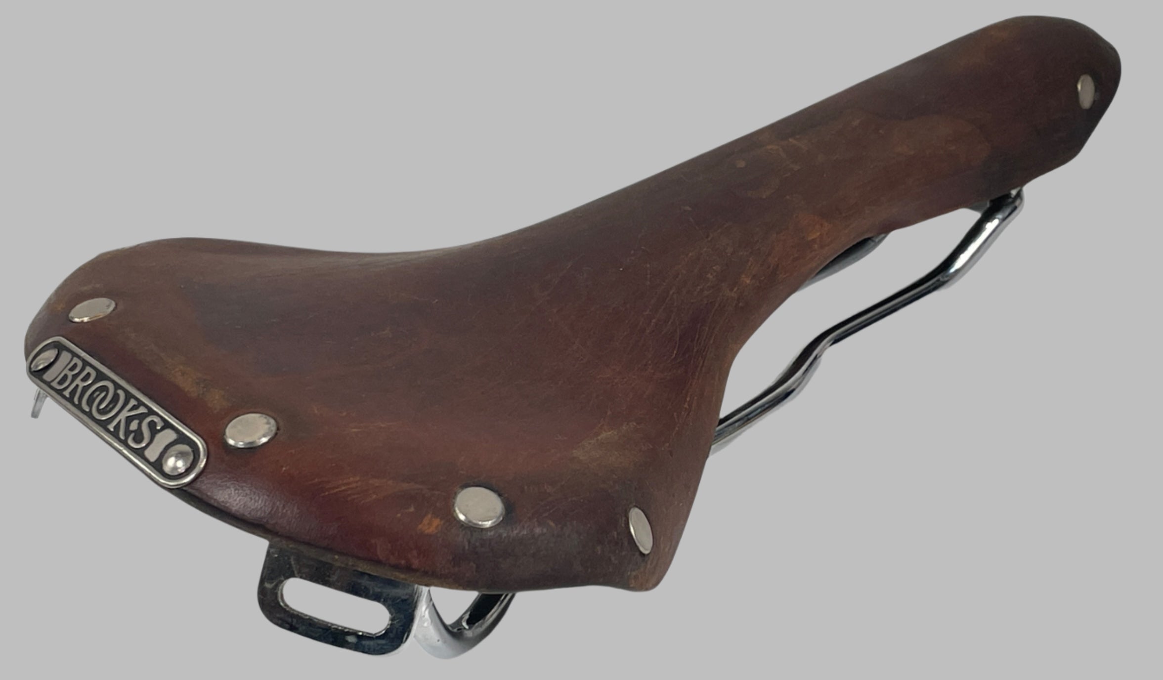 Brooks, England, Brown bicycle saddle with 'Brooks' branding on a white background