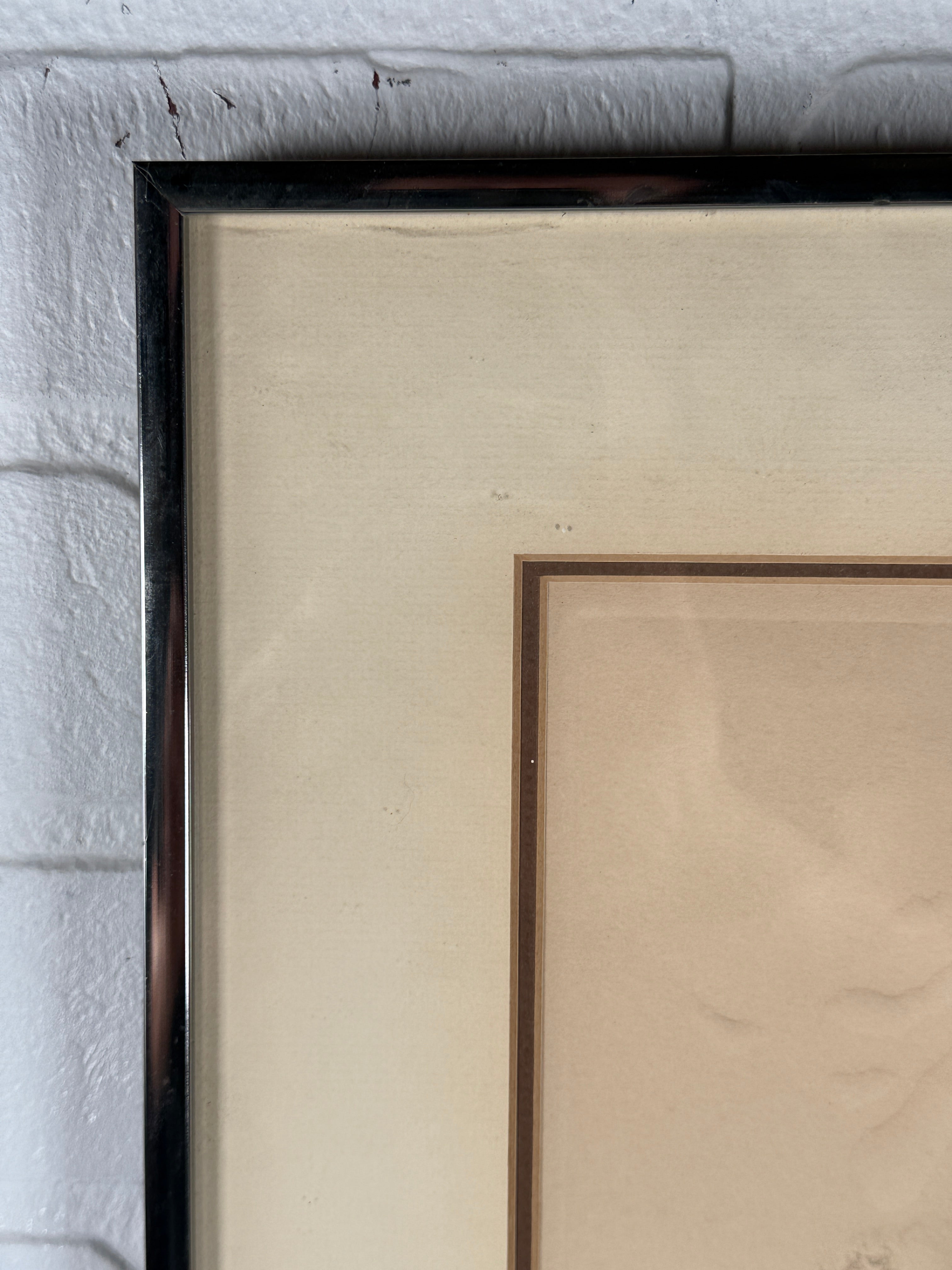 Framed artwork on a textured wall
