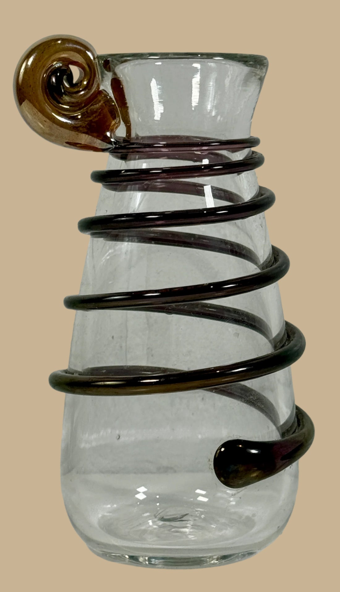 Clear glass vase with black spiral design on a white background