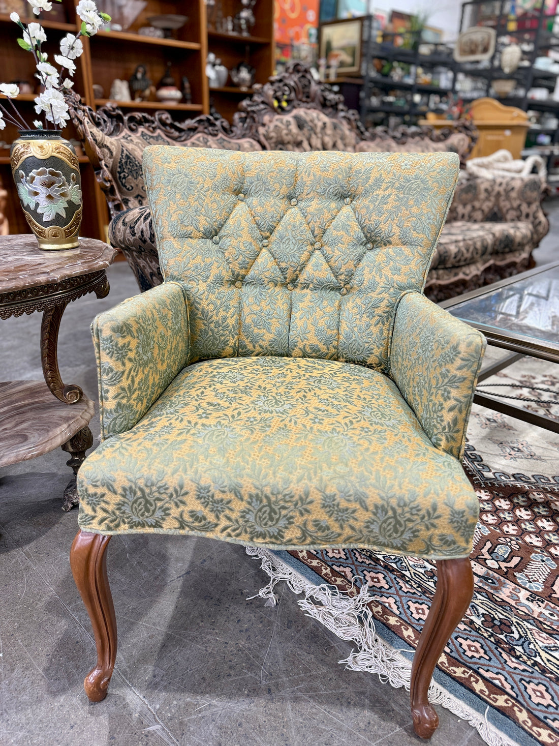 Vintage damask accent chair with tufted back and cabriole legs. Classic traditional furniture piece ideal for living room seating or decorative vintage interiors.