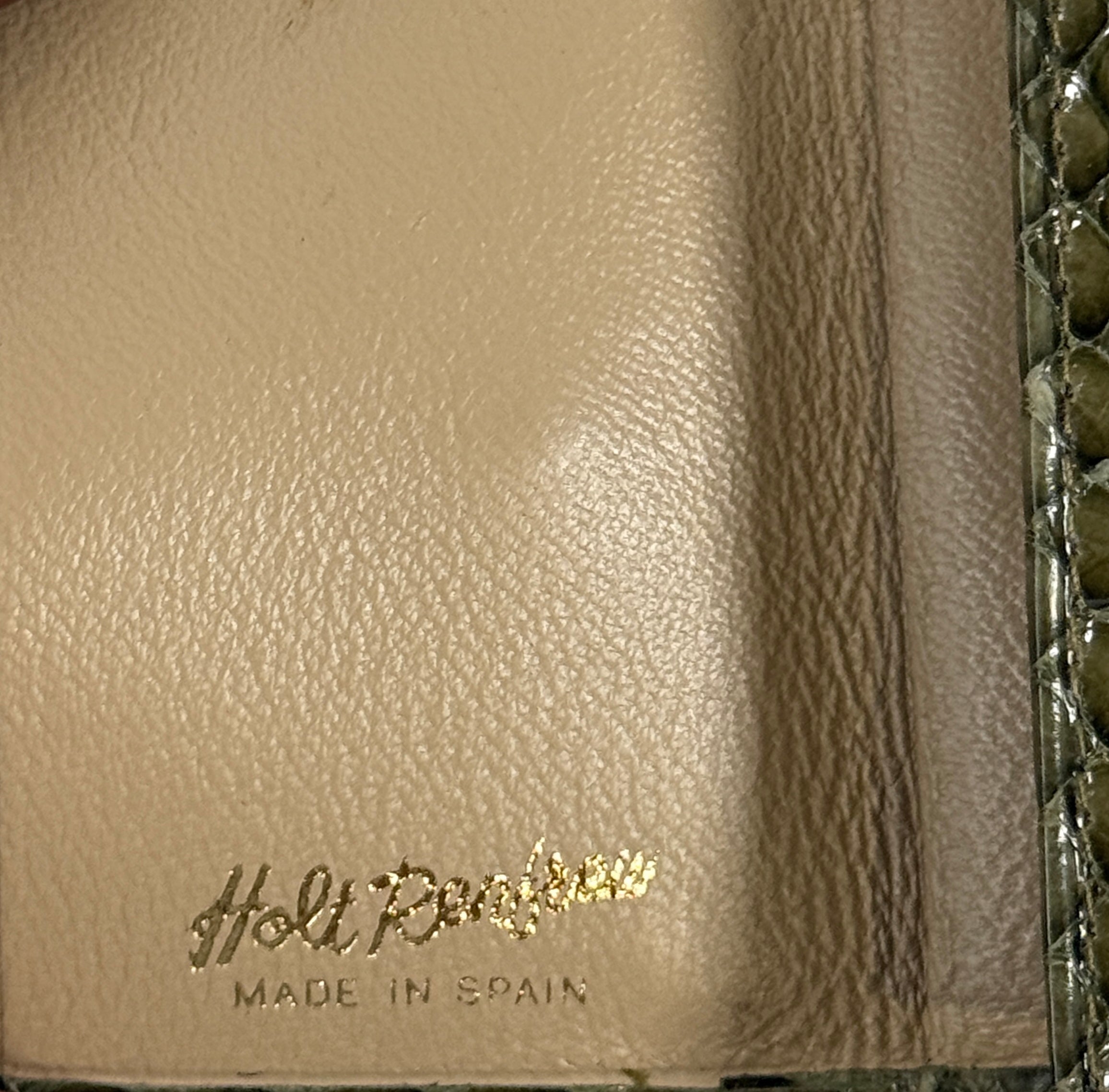 Beige leather product with 'Holt Renfrew' branding and 'Made in Spain' text.