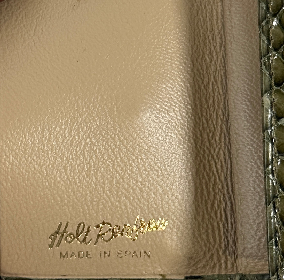 Beige leather product with 'Holt Renfrew' branding and 'Made in Spain' text.