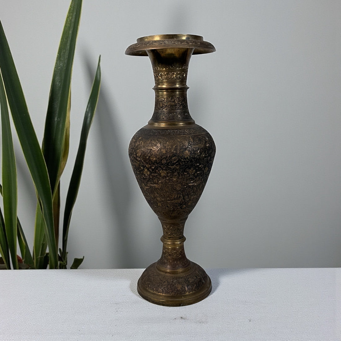 Vintage Indian brass vase with hand-chased bird and floral motifs, 16.5" tall. Mid-century décor with patina. Ships worldwide from Montreal.