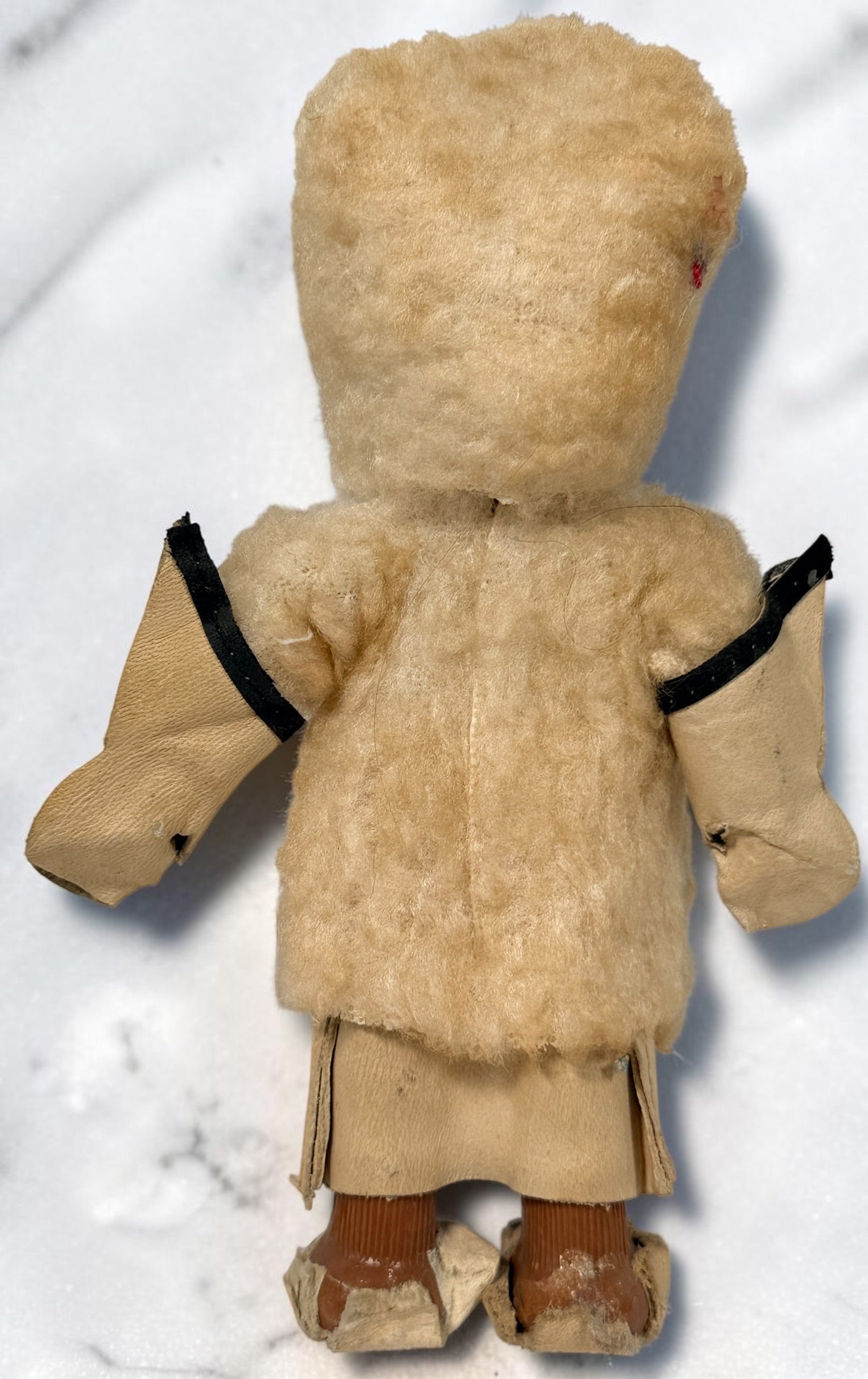 Vintage Hong Kong Inuit-style souvenir doll with sleep eyes, faux-fur parka and beaded footwear. 1960s–1970s collectible in worn condition.