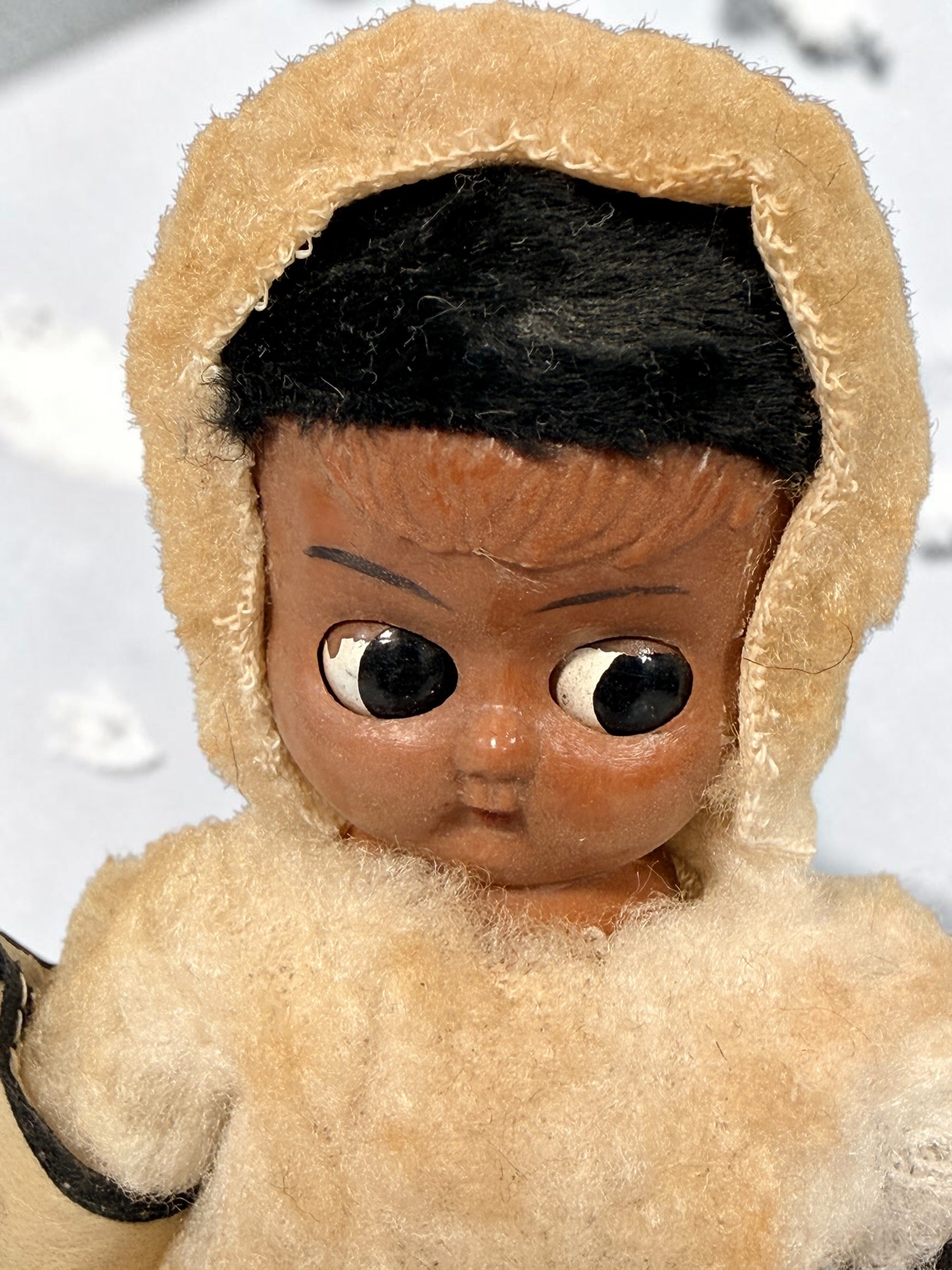 Vintage Hong Kong Inuit-style souvenir doll with sleep eyes, faux-fur parka and beaded footwear. 1960s–1970s collectible in worn condition.