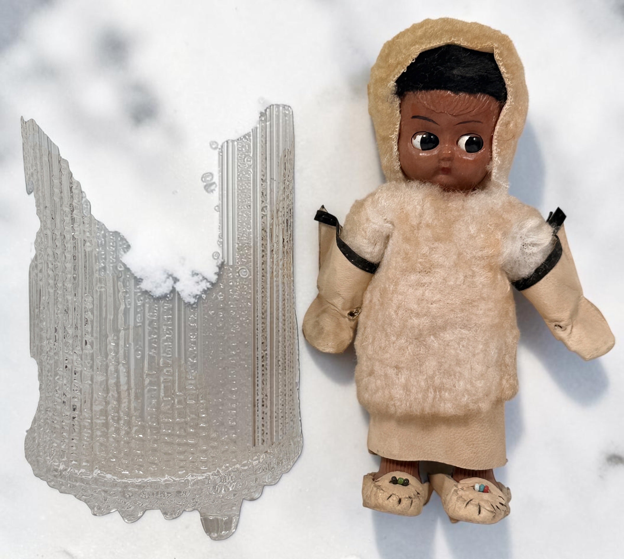 Vintage Hong Kong Inuit-style souvenir doll with sleep eyes, faux-fur parka and beaded footwear. 1960s–1970s collectible in worn condition.