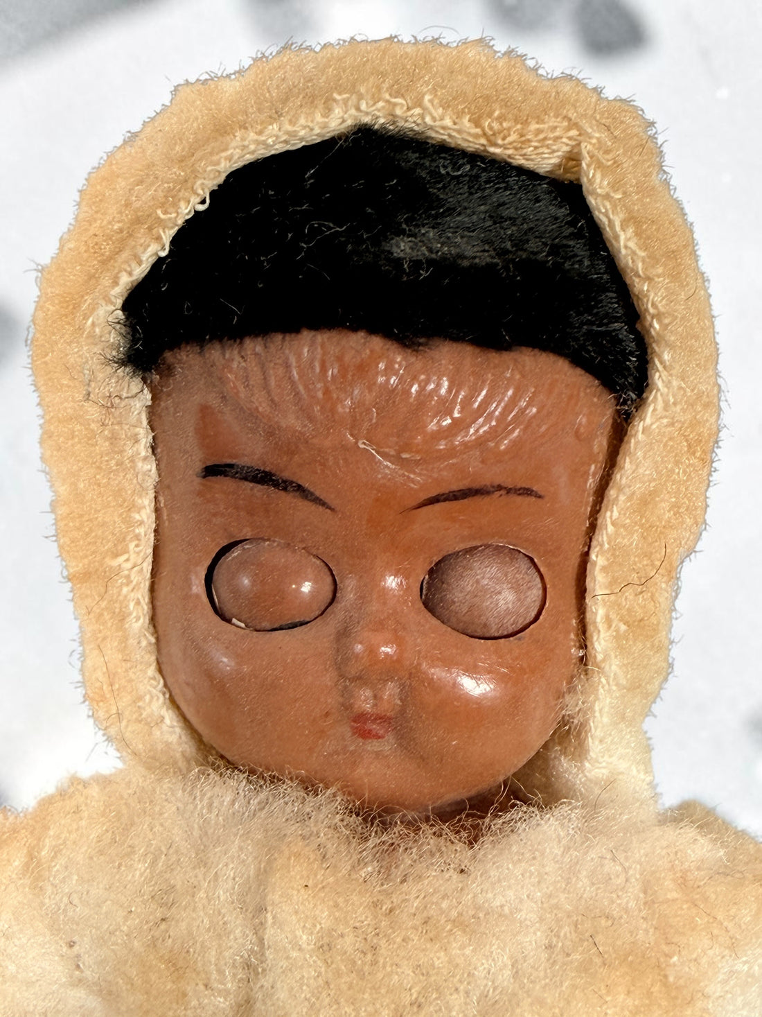 Vintage Hong Kong Inuit-style souvenir doll with sleep eyes, faux-fur parka and beaded footwear. 1960s–1970s collectible in worn condition.
