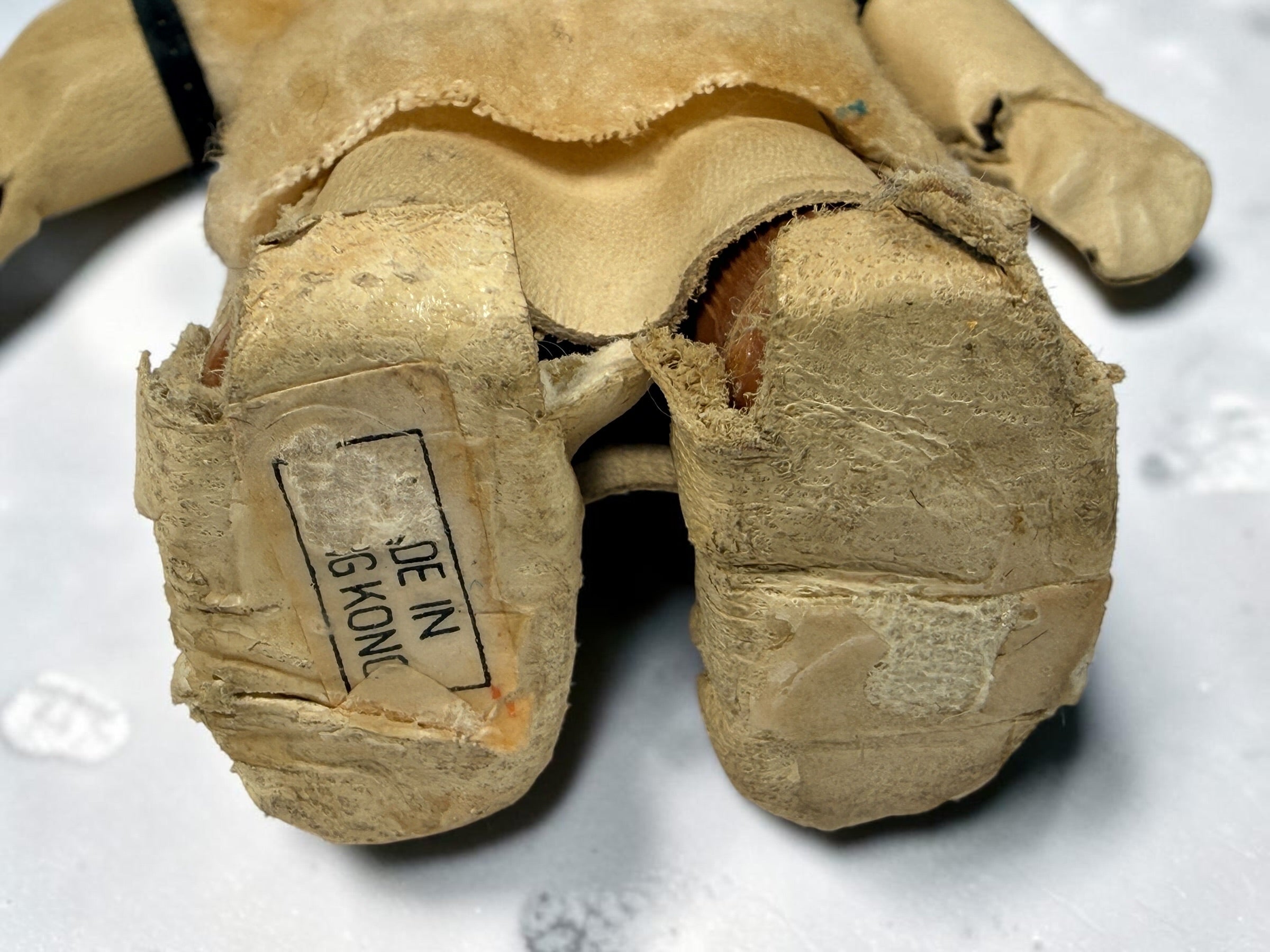Vintage Hong Kong Inuit-style souvenir doll with sleep eyes, faux-fur parka and beaded footwear. 1960s–1970s collectible in worn condition.