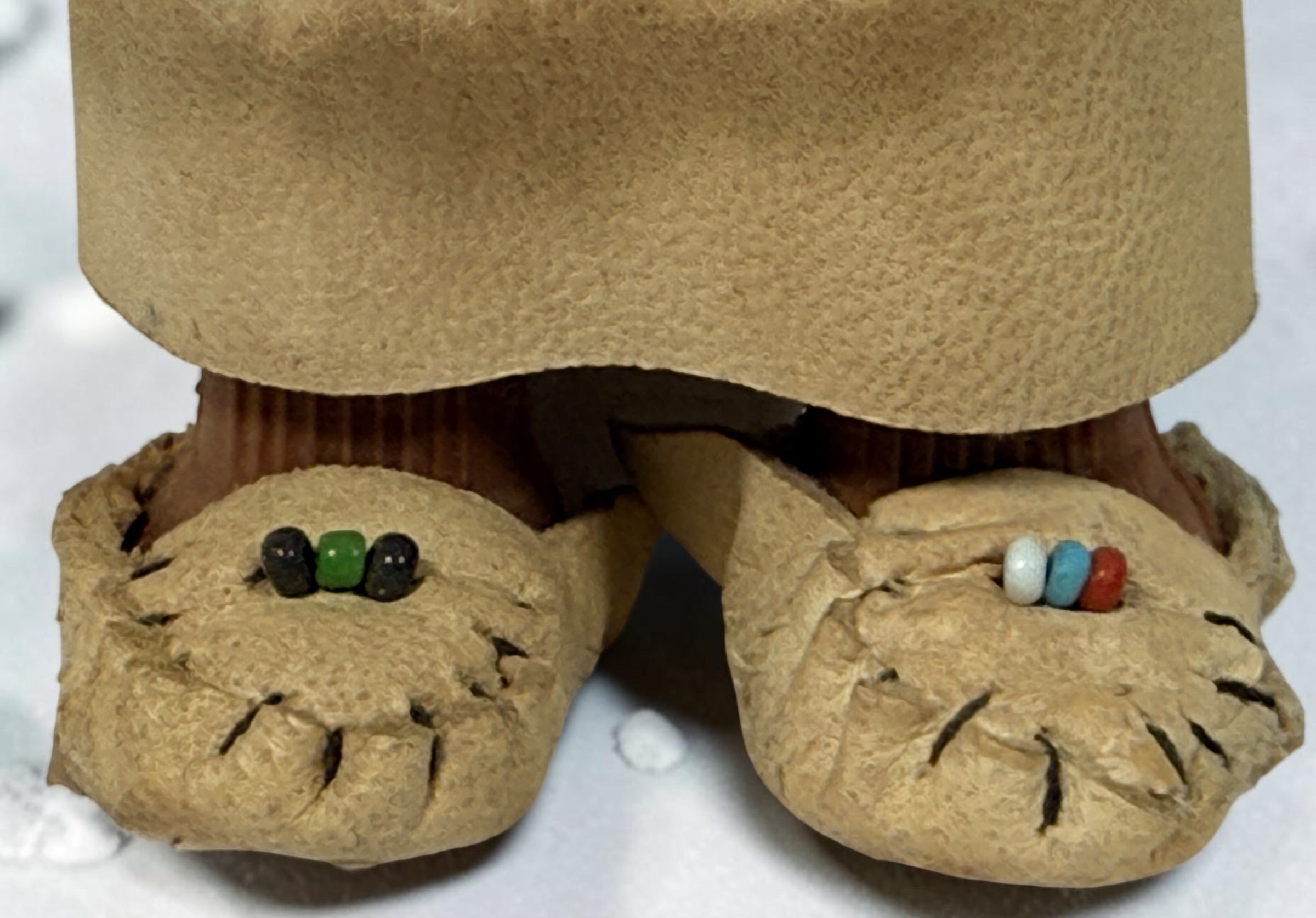Vintage Hong Kong Inuit-style souvenir doll with sleep eyes, faux-fur parka and beaded footwear. 1960s–1970s collectible in worn condition.