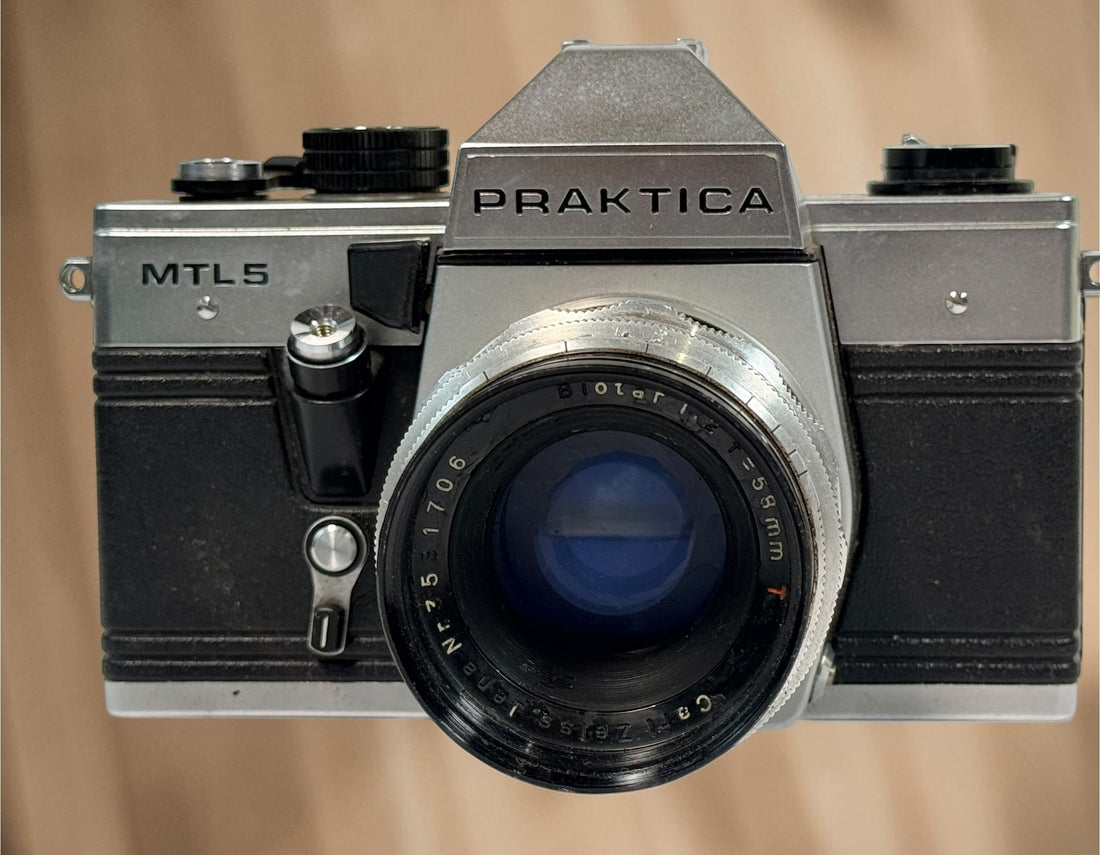 Vintage Praktica MTL 5 East German 35mm SLR with Carl Zeiss Jena Biotar 58mm f/2 M42 lens, cases and strap. Untested and sold as-is.