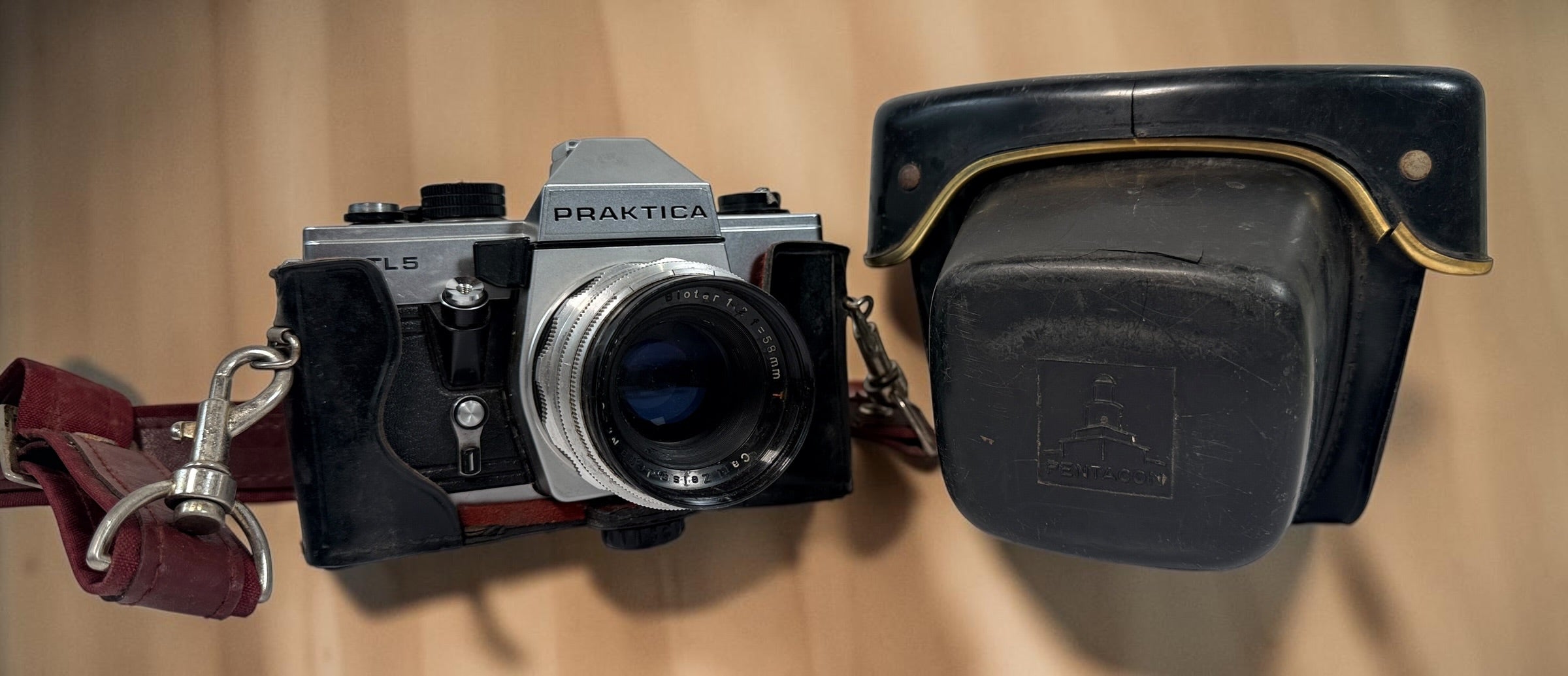 Vintage Praktica MTL 5 East German 35mm SLR with Carl Zeiss Jena Biotar 58mm f/2 M42 lens, cases and strap. Untested and sold as-is.