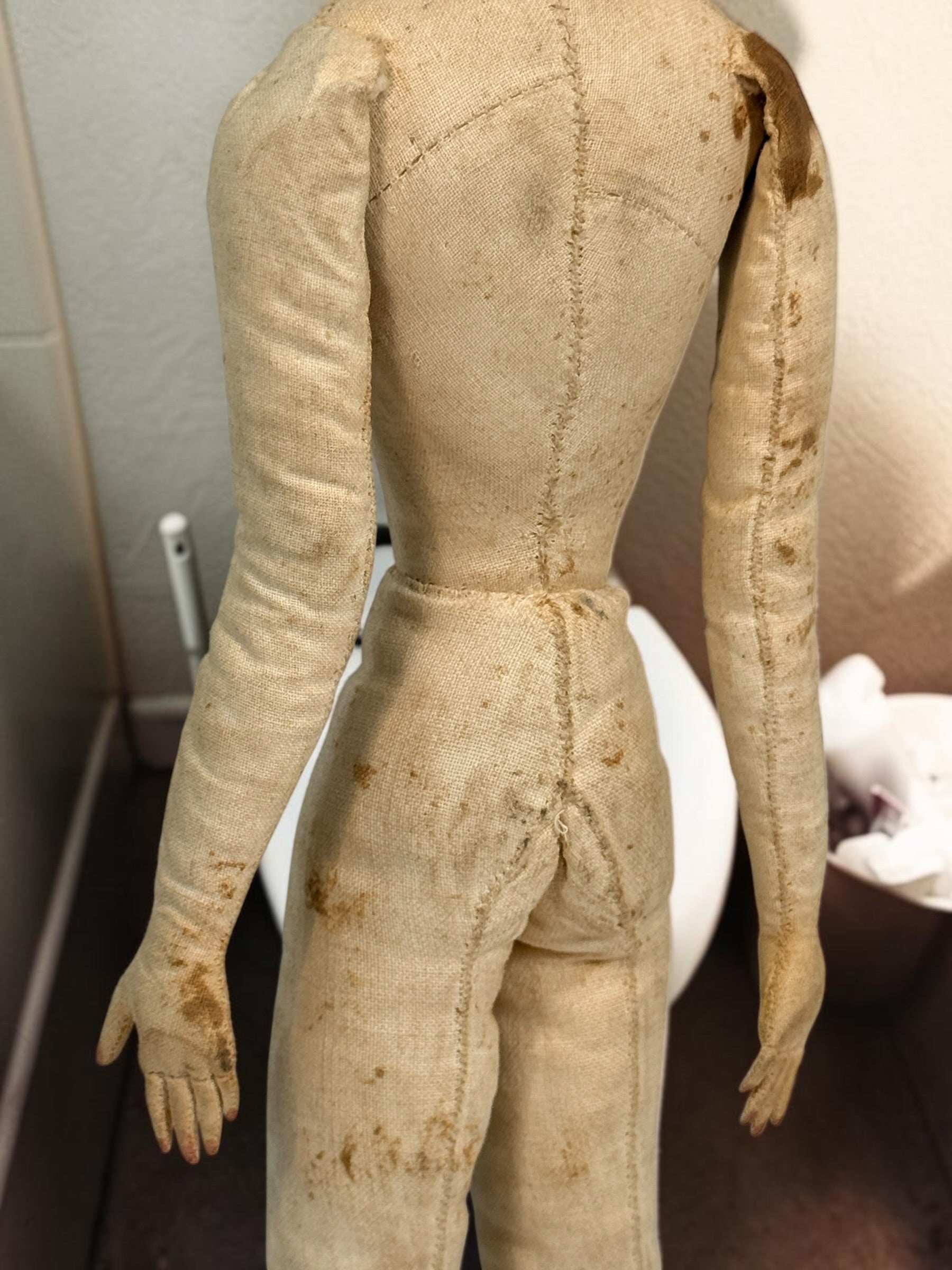Antique handmade cloth folk art doll with embroidered face, blue bead eyes, braided brown hair and individually sewn fingers. Heavily aged condition.