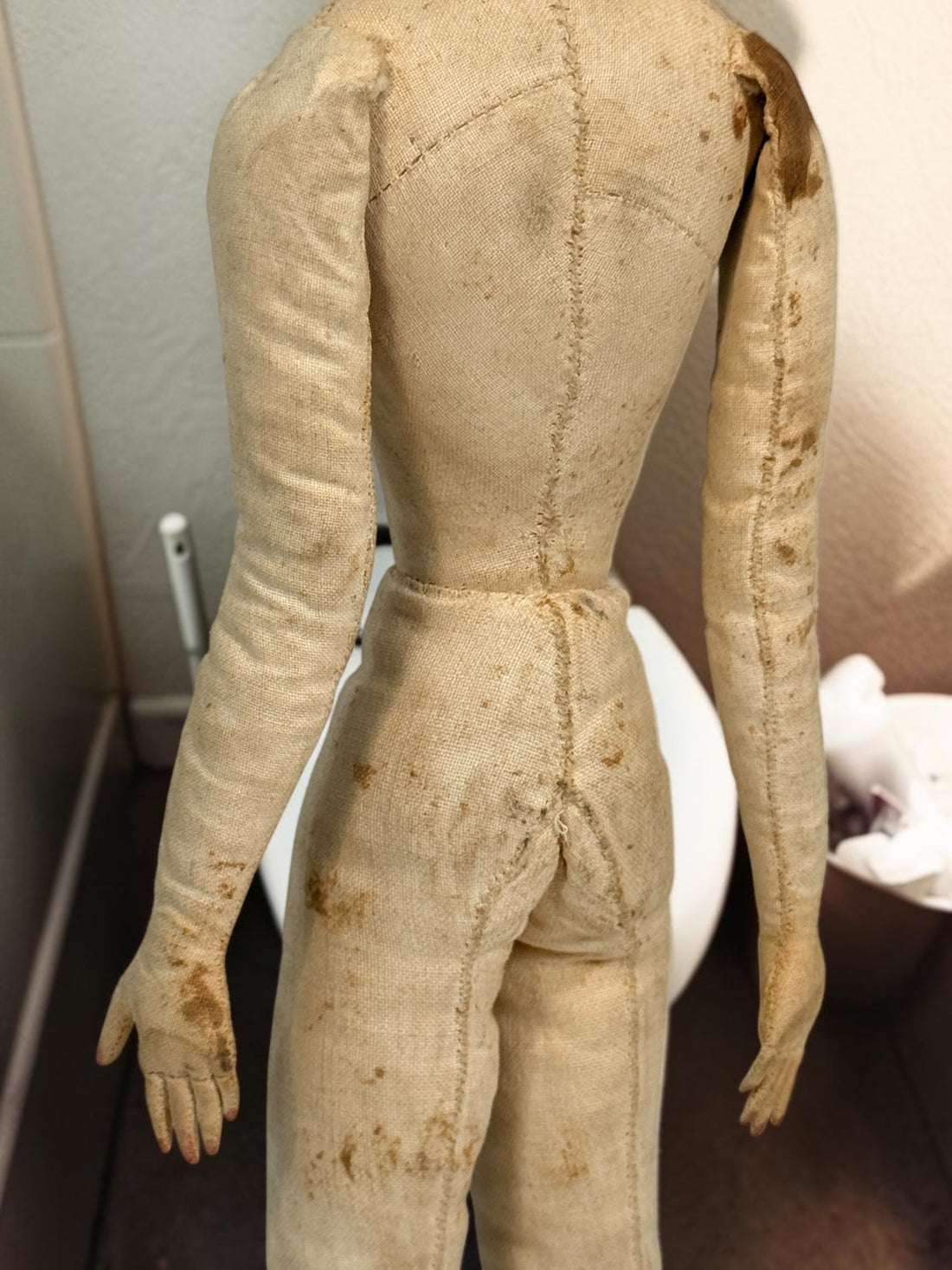 Antique handmade cloth folk art doll with embroidered face, blue bead eyes, braided brown hair and individually sewn fingers. Heavily aged condition.