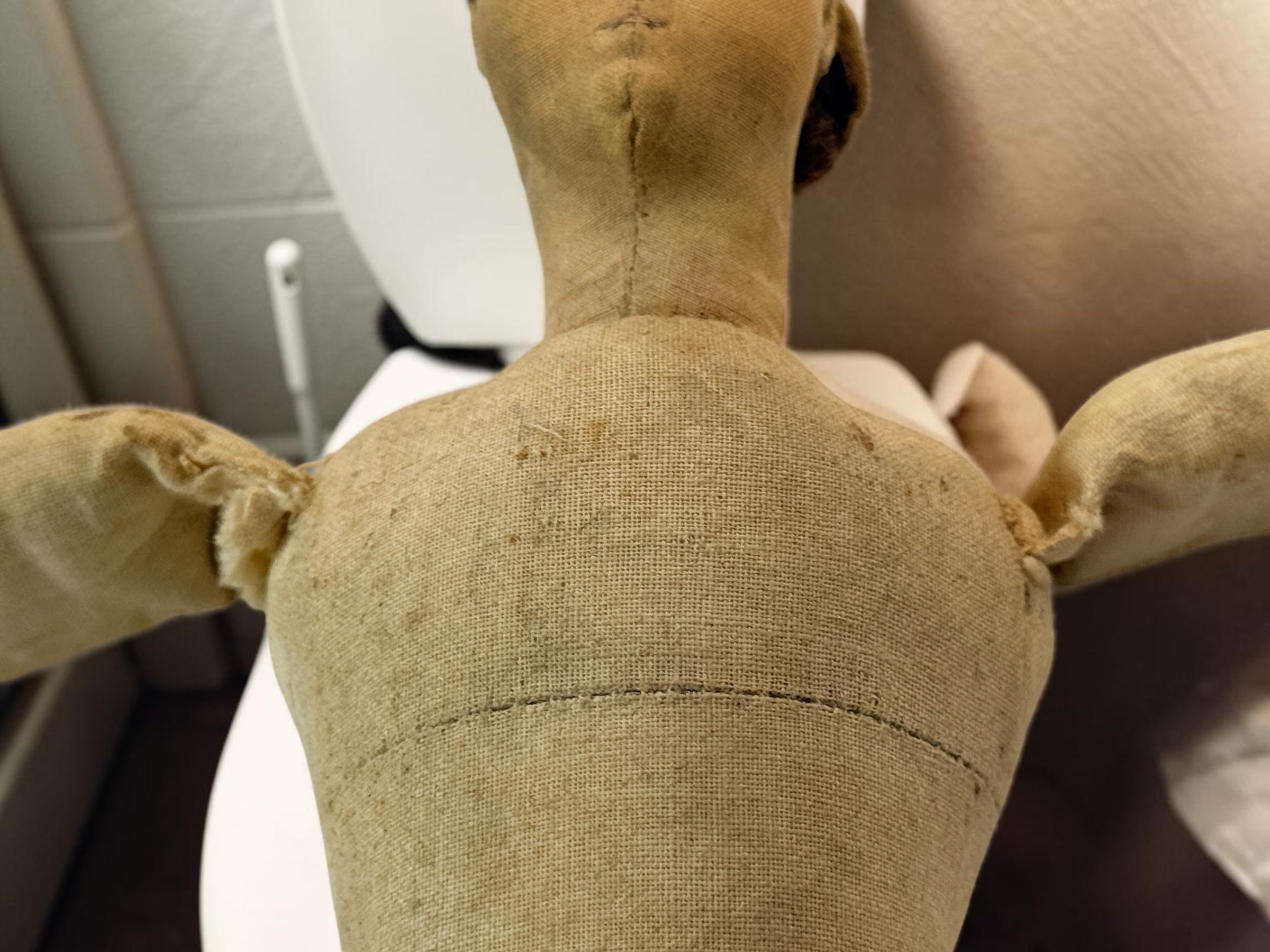 Antique handmade cloth folk art doll with embroidered face, blue bead eyes, braided brown hair and individually sewn fingers. Heavily aged condition.