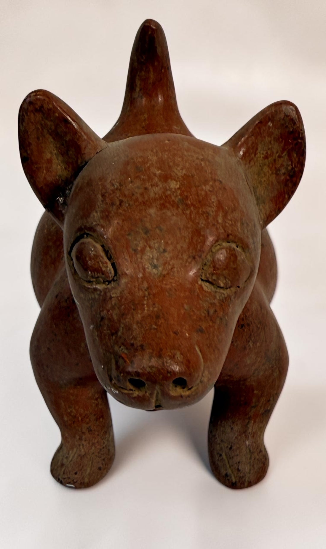 Vintage Mexican Colima-style redware pottery dog with aged patina, expressive teeth and GP mark. Decorative pre-Columbian revival folk art.
