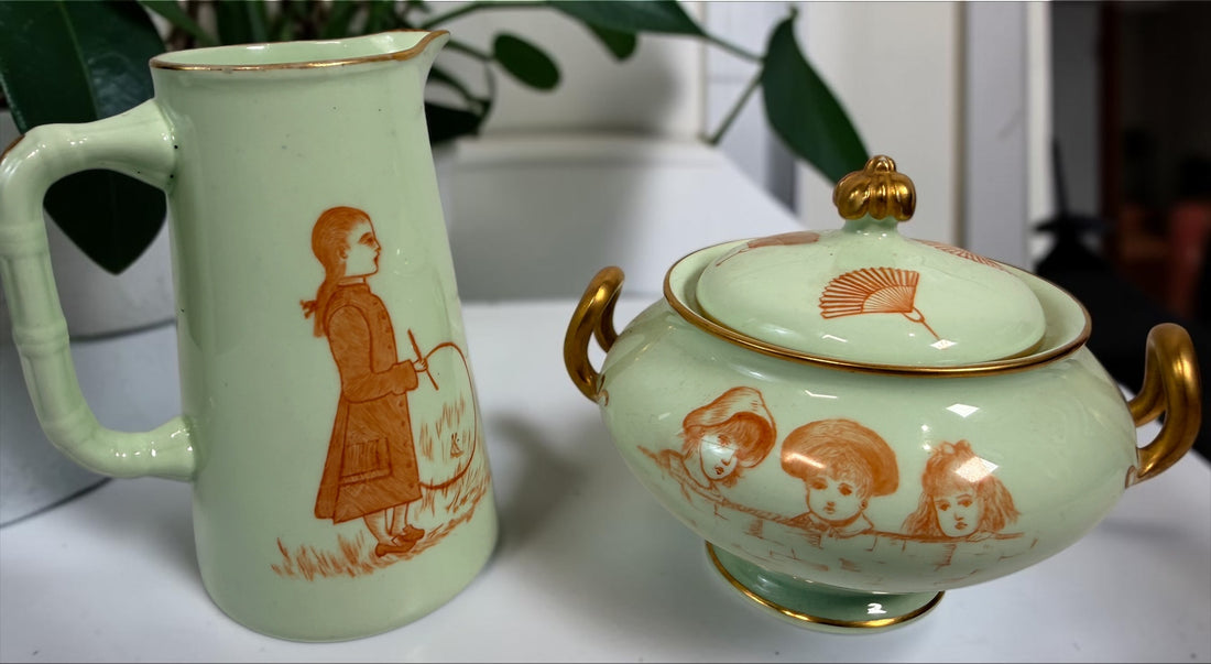 Celadon porcelain wash set with pitcher and covered chamber pot, hand-painted children, gold trim and M.A.P. signature; antique or vintage replica status unconfirmed.
