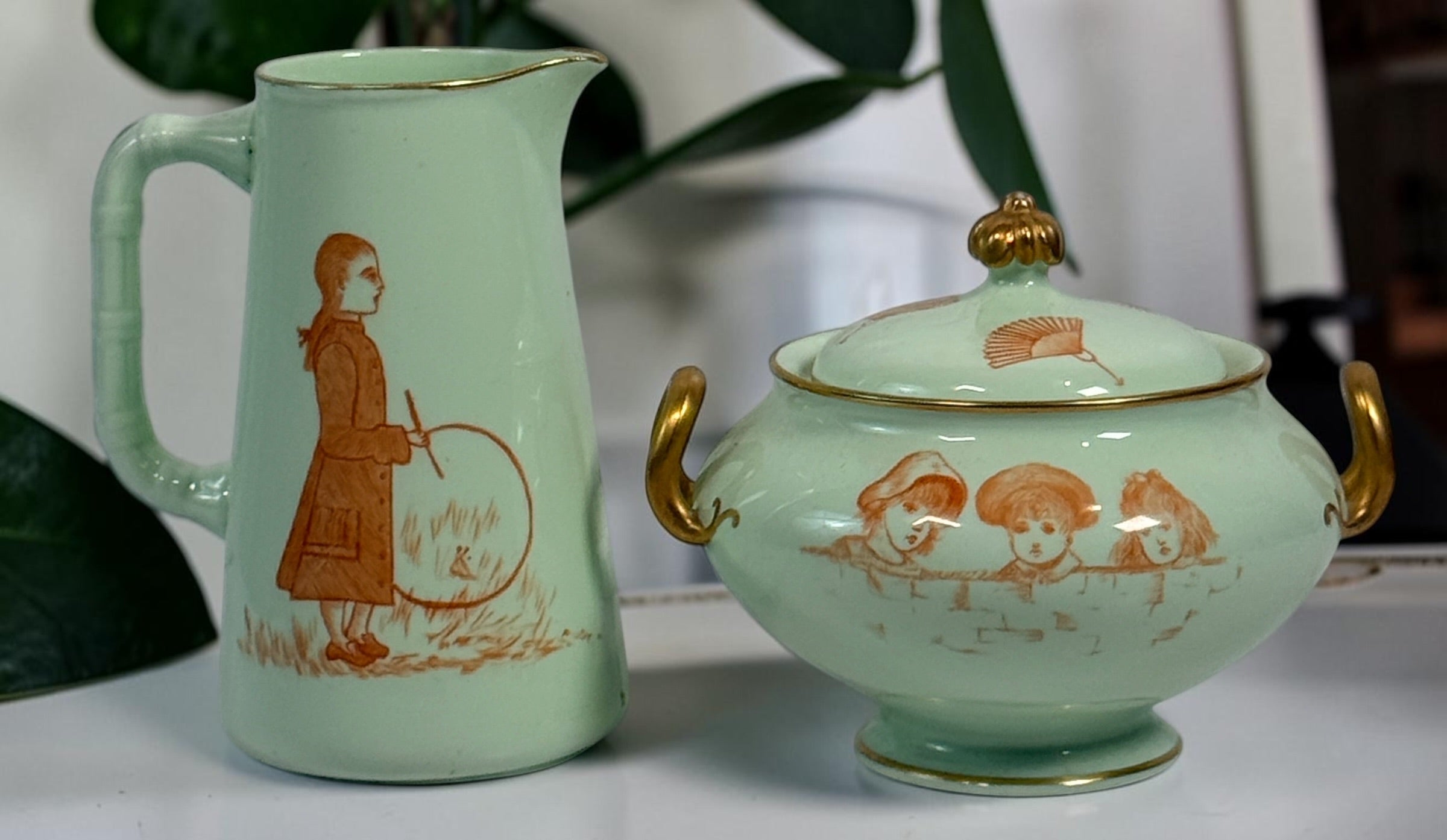 Celadon porcelain wash set with pitcher and covered chamber pot, hand-painted children, gold trim and M.A.P. signature; antique or vintage replica status unconfirmed.
