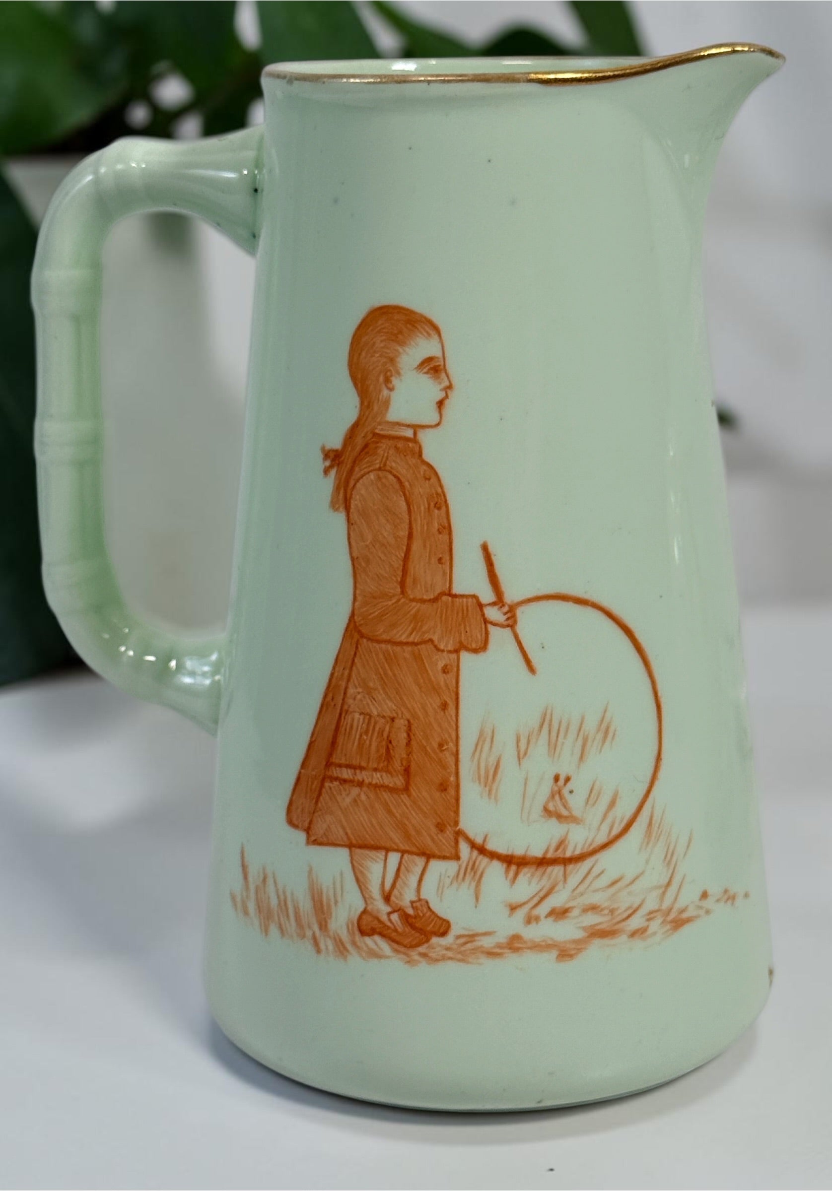 Celadon porcelain wash set with pitcher and covered chamber pot, hand-painted children, gold trim and M.A.P. signature; antique or vintage replica status unconfirmed.